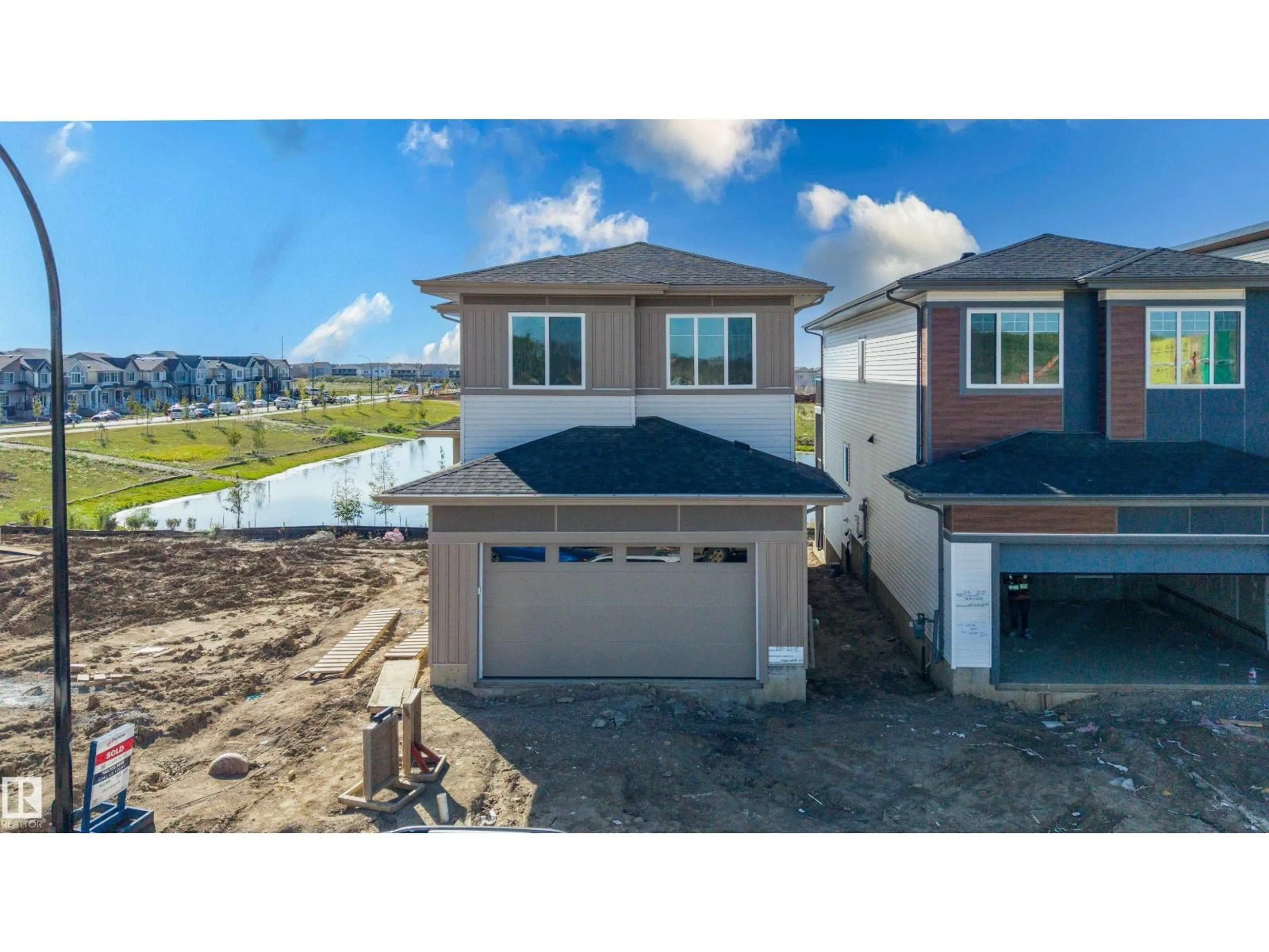 A pic from outside/outdoor area/front of a property/back of a property/a pic from drone, water/lake/river/ocean view for SW - 220 21 ST, Edmonton Alberta T6X3C9