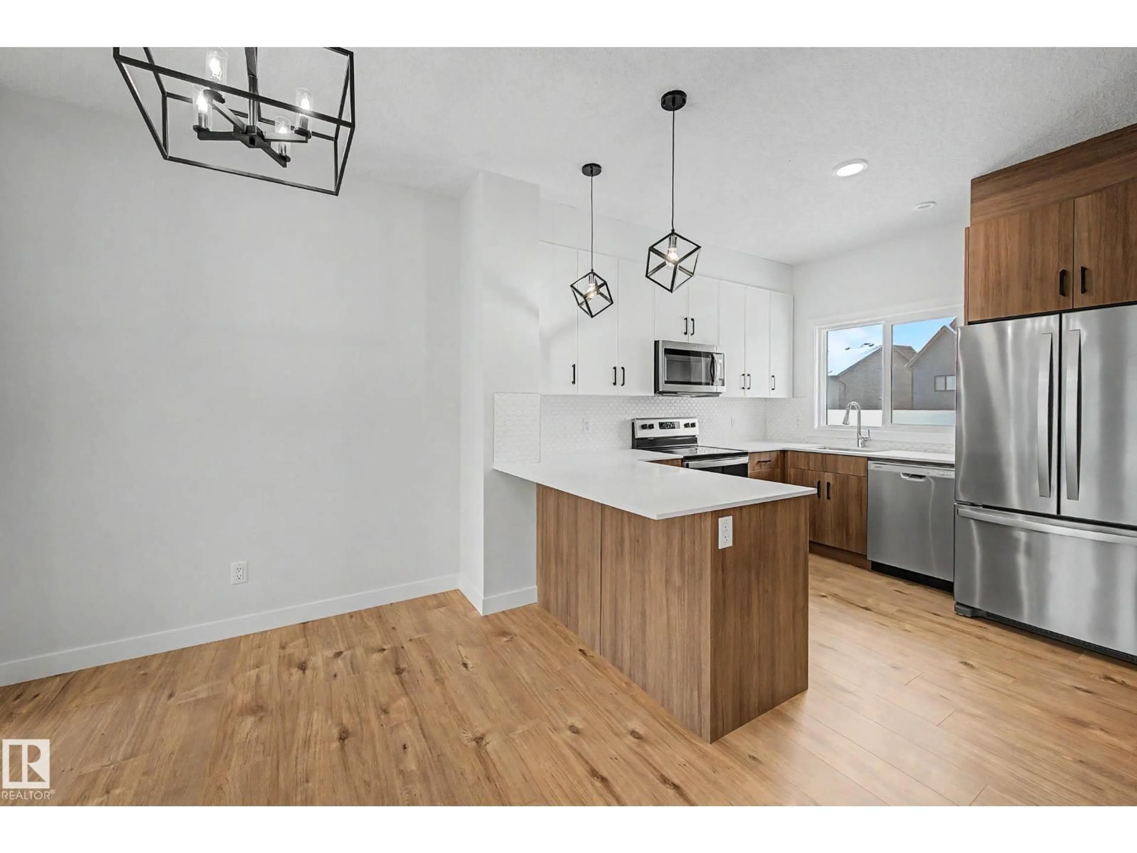 Open concept kitchen, wood/laminate floor for 6214 - 24 CARTMELL CO, Edmonton Alberta T6W5A7