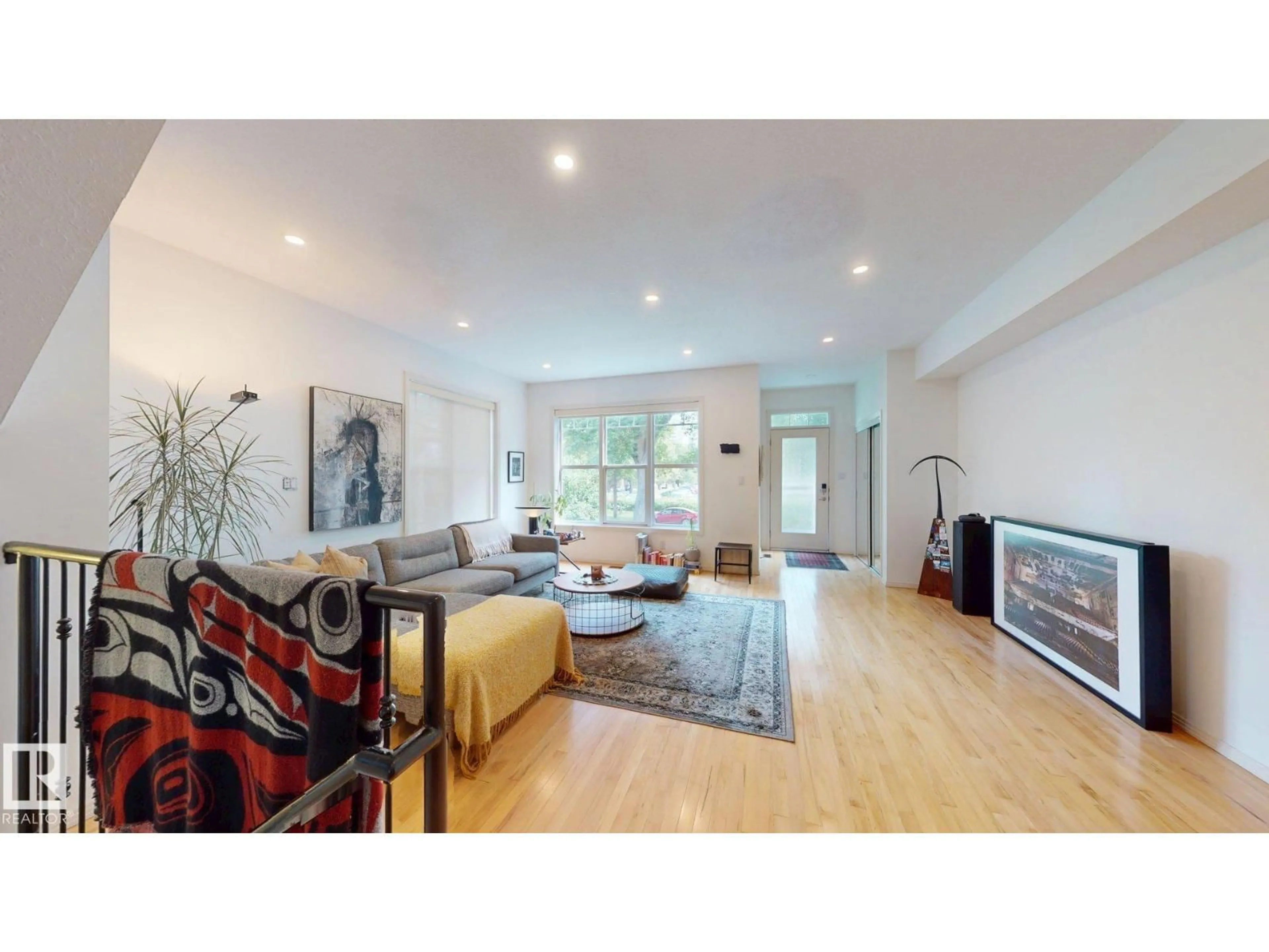 Living room with furniture, wood/laminate floor for NW - 9846 112 ST, Edmonton Alberta T5K1L4