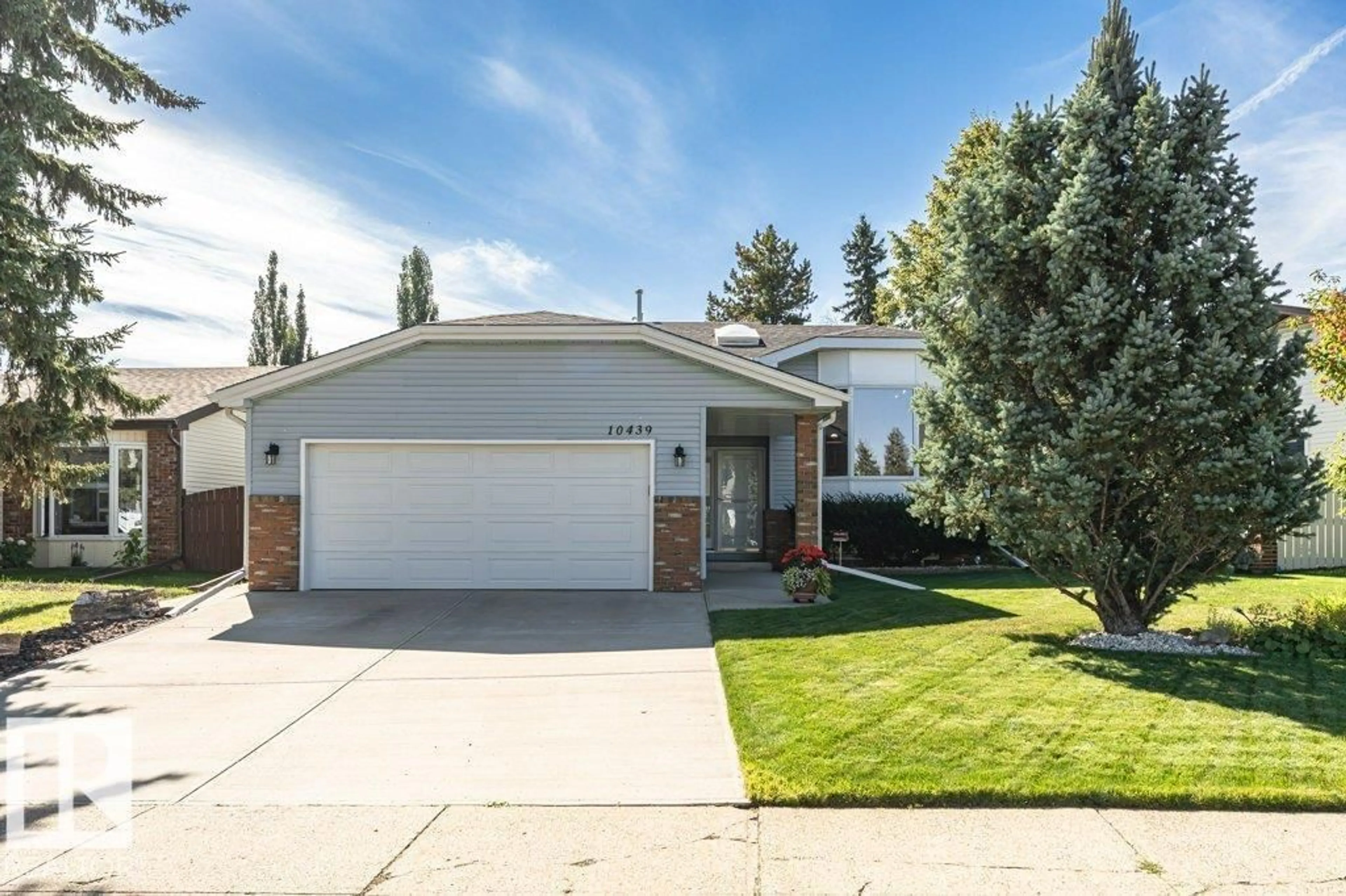 Home with vinyl exterior material, street for 10439 14 AV NW, Edmonton Alberta T6J5R7