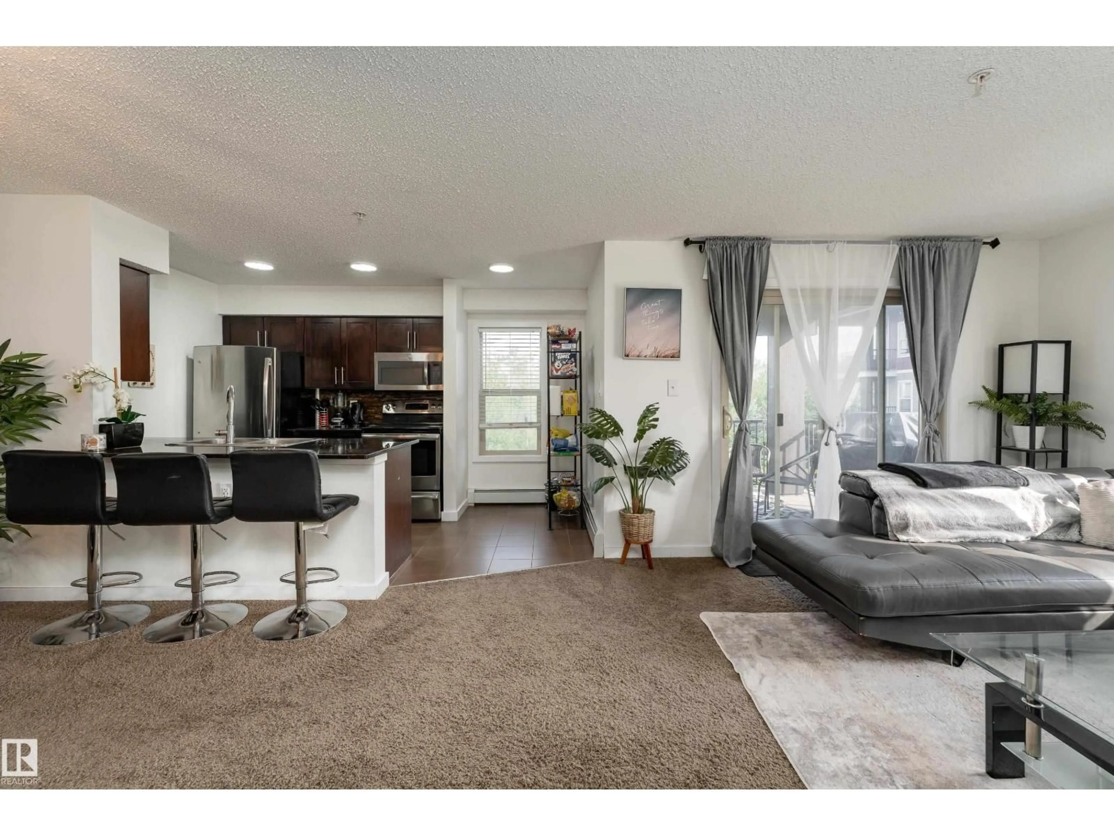 Living room with furniture, unknown for 1060 - 317 MCCONACHIE BV, Edmonton Alberta T5Y0W9