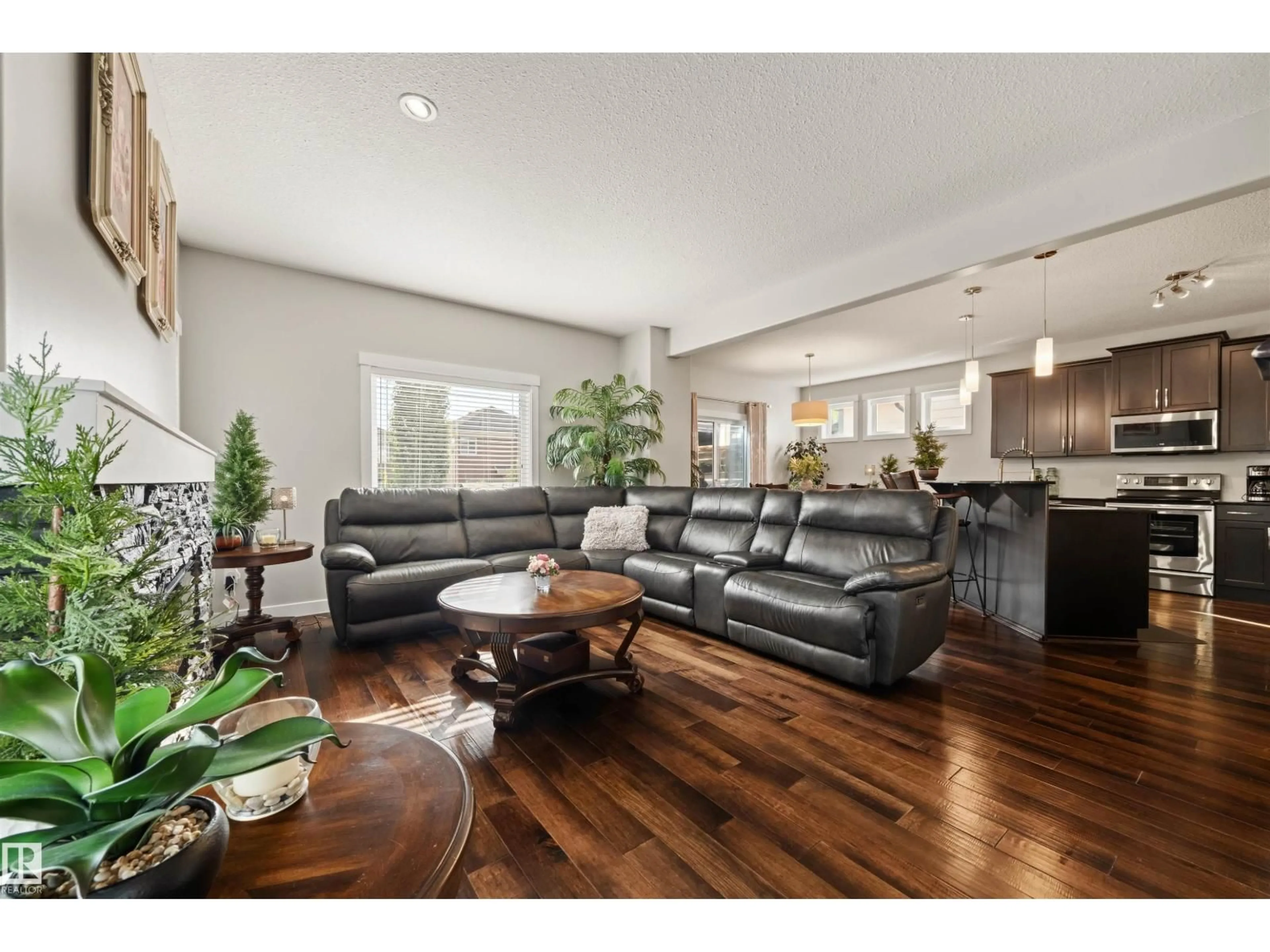 Living room with furniture, wood/laminate floor for 1457 WATES LI SW, Edmonton Alberta T6W0V1