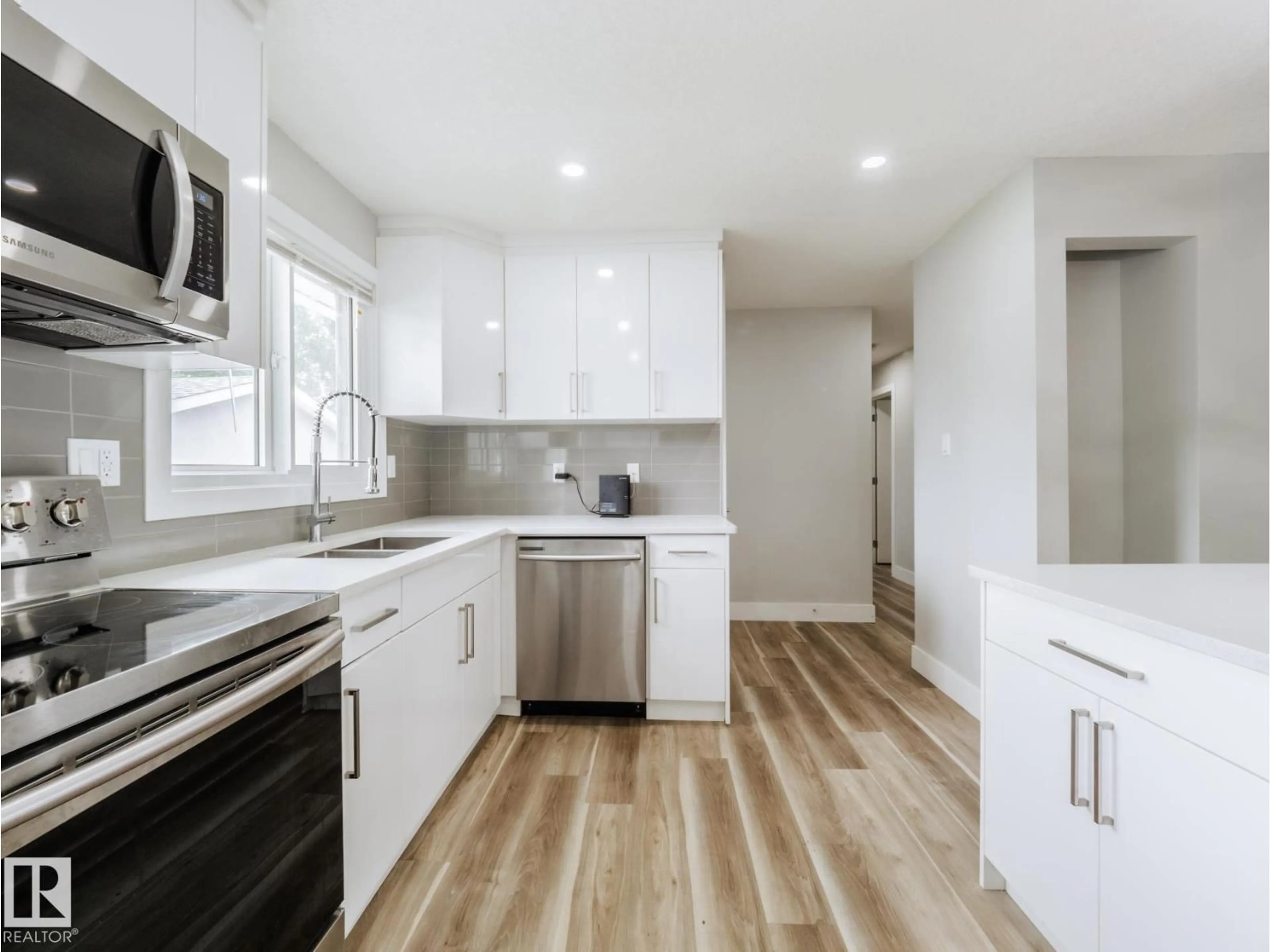 Open concept kitchen, wood/laminate floor for NW - 15011 59 ST, Edmonton Alberta T5A1Y6