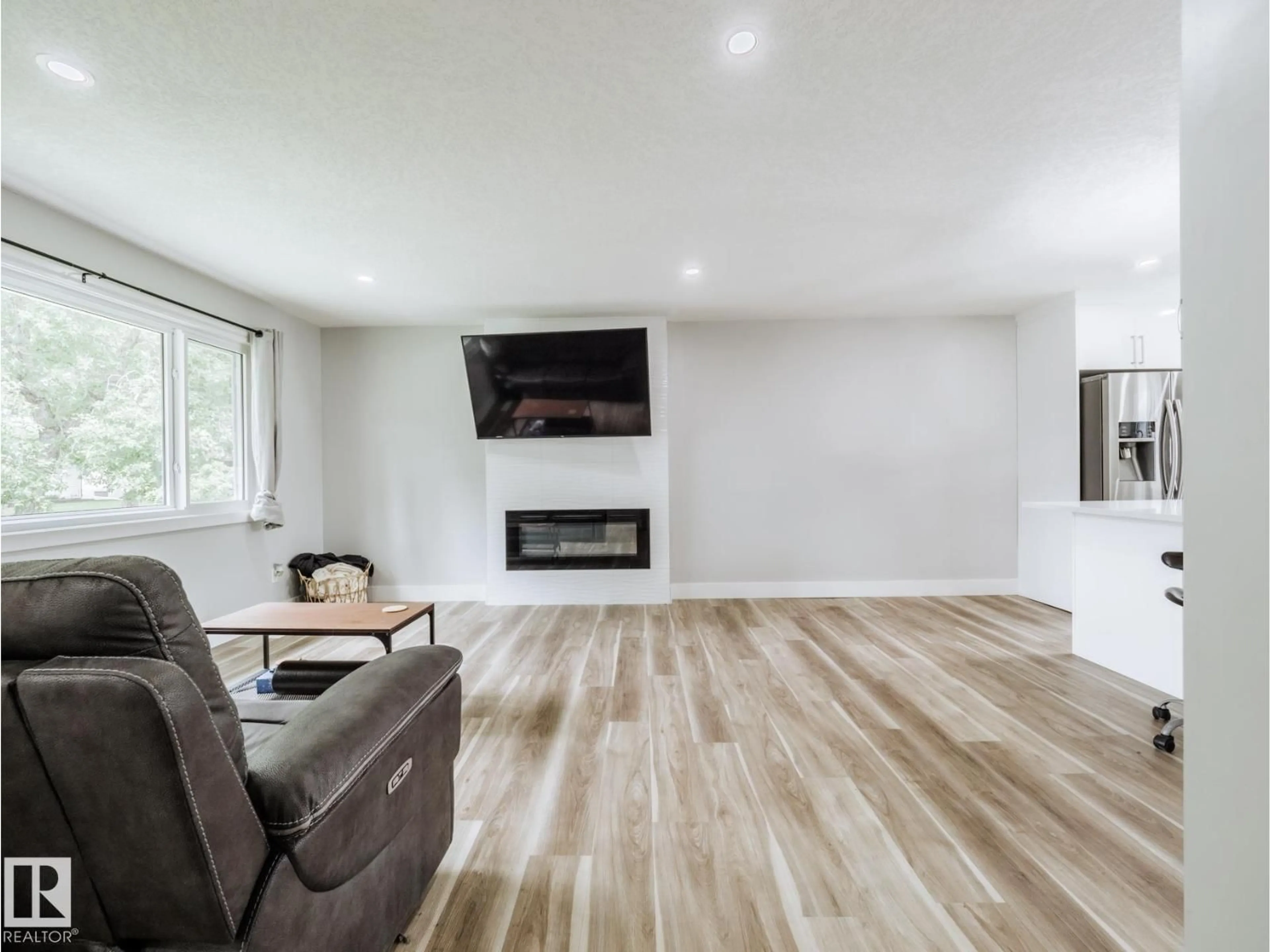 Living room with furniture, wood/laminate floor for NW - 15011 59 ST, Edmonton Alberta T5A1Y6