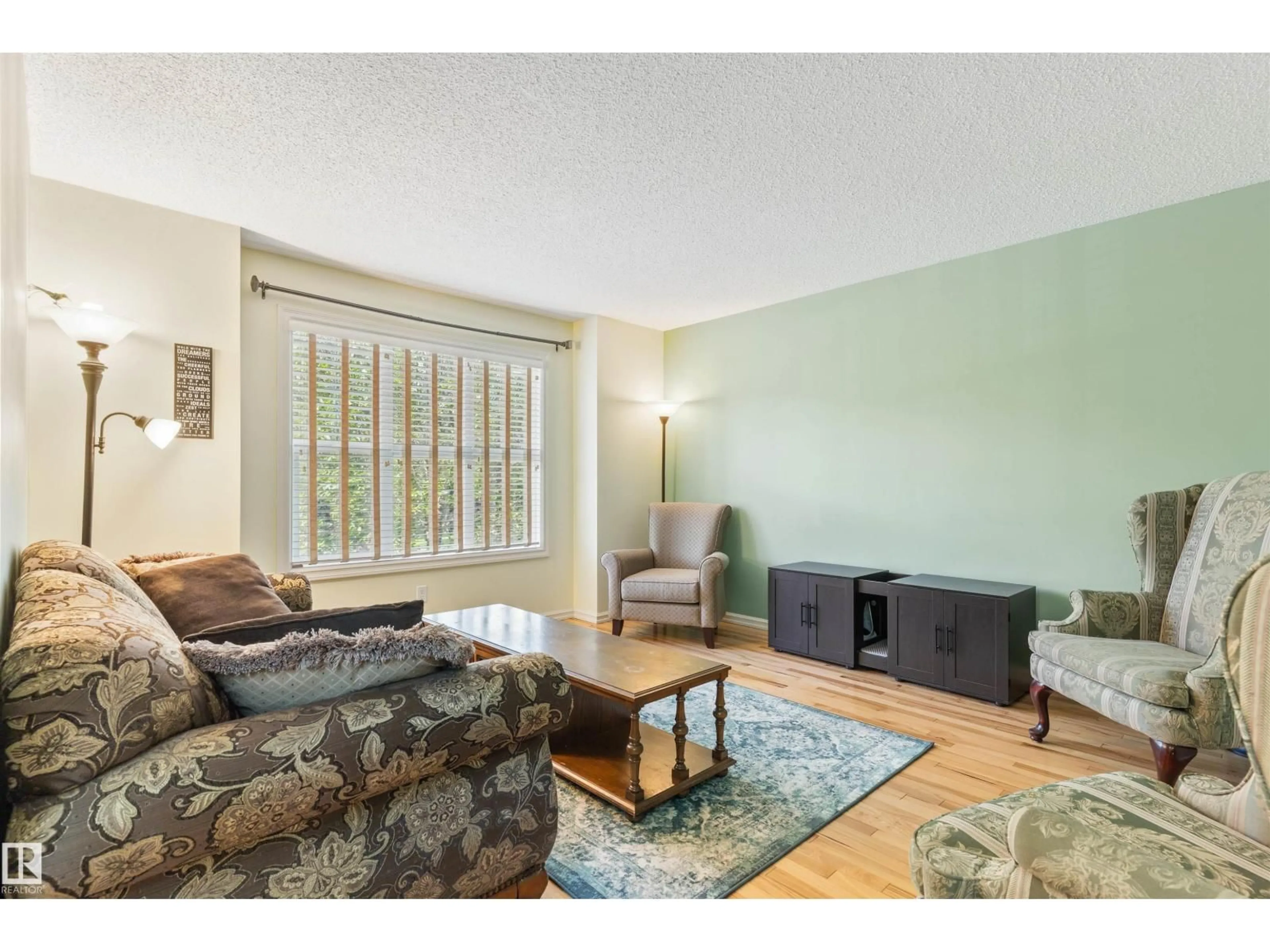 Living room with furniture, wood/laminate floor for 415 KEYSTONE WY, Leduc Alberta T9E0M6