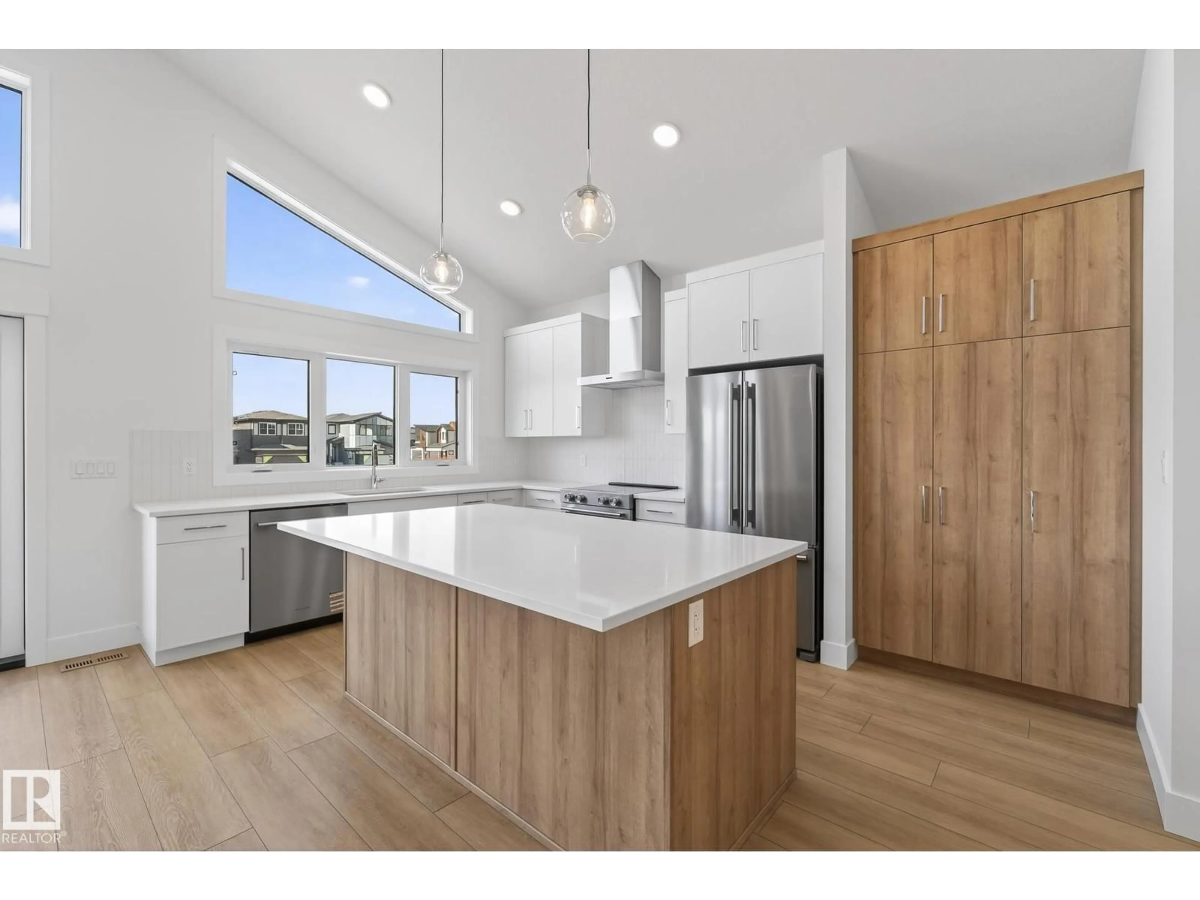 Open concept kitchen, wood/laminate floor for 7093 KIVIAQ CR, Edmonton Alberta T6W5N7