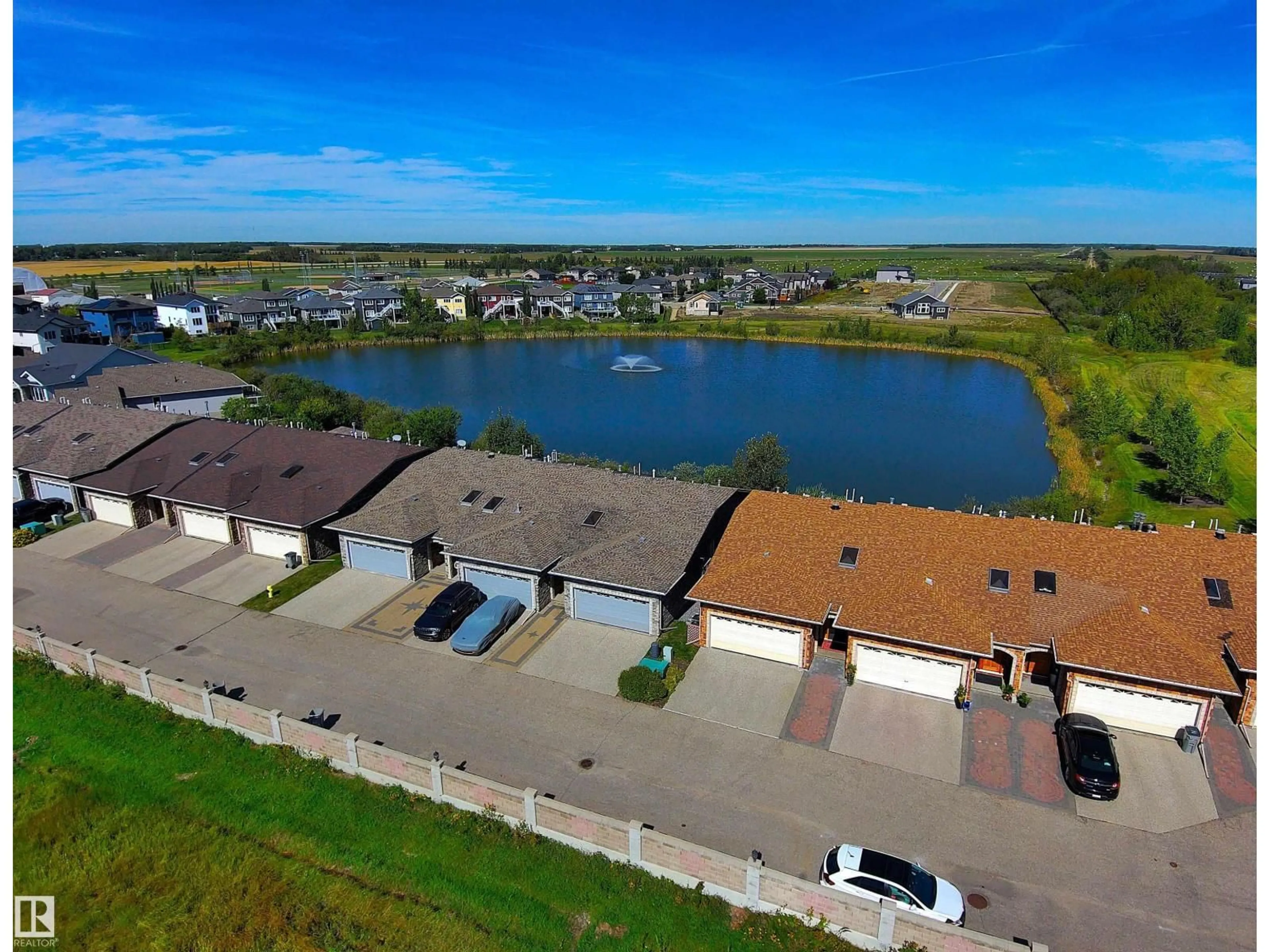 A pic from outside/outdoor area/front of a property/back of a property/a pic from drone, water/lake/river/ocean view for 10 10500 103 AV, Morinville Alberta T8R0E7