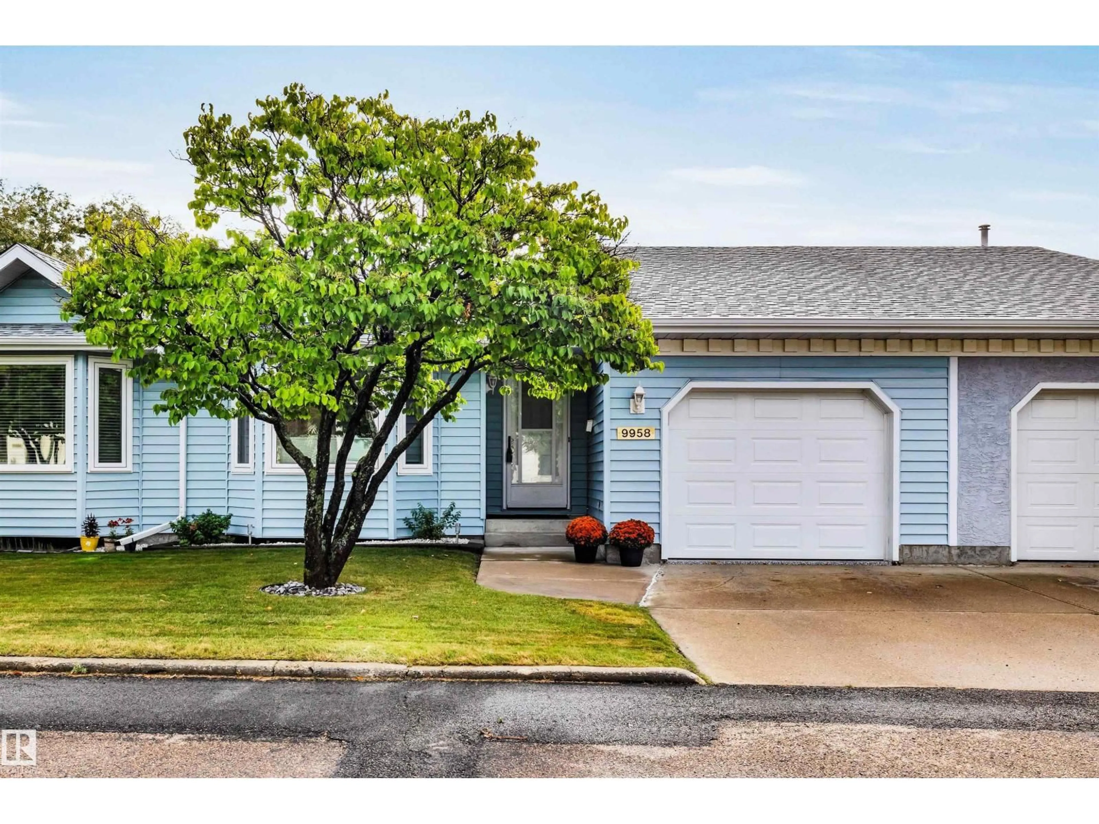 Home with vinyl exterior material, street for NW - 9958 176 AV, Edmonton Alberta T5X5W1