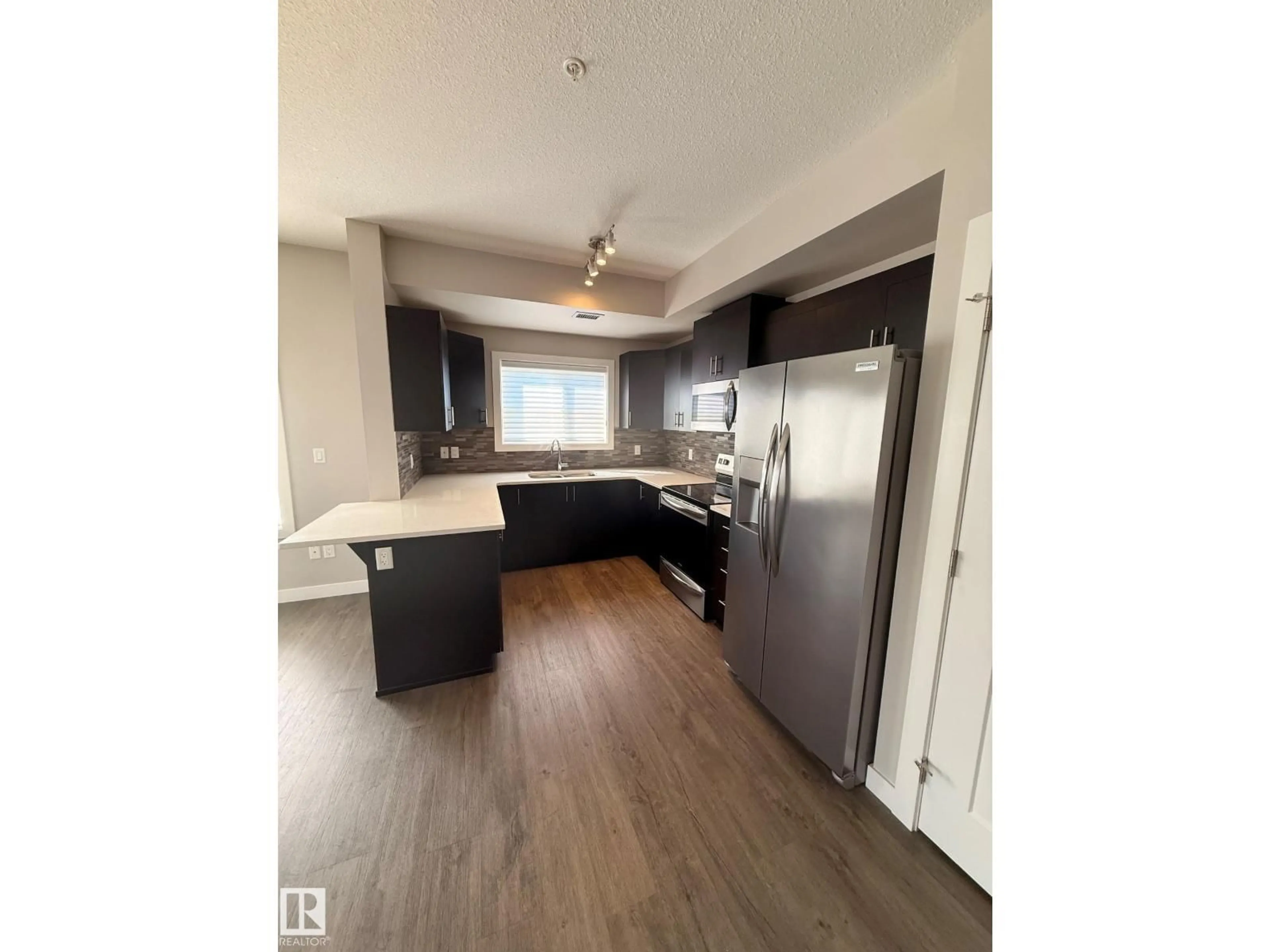 Open concept kitchen, unknown for #306 - 560 GRIESBACH PARADE, Edmonton Alberta T5E6X1