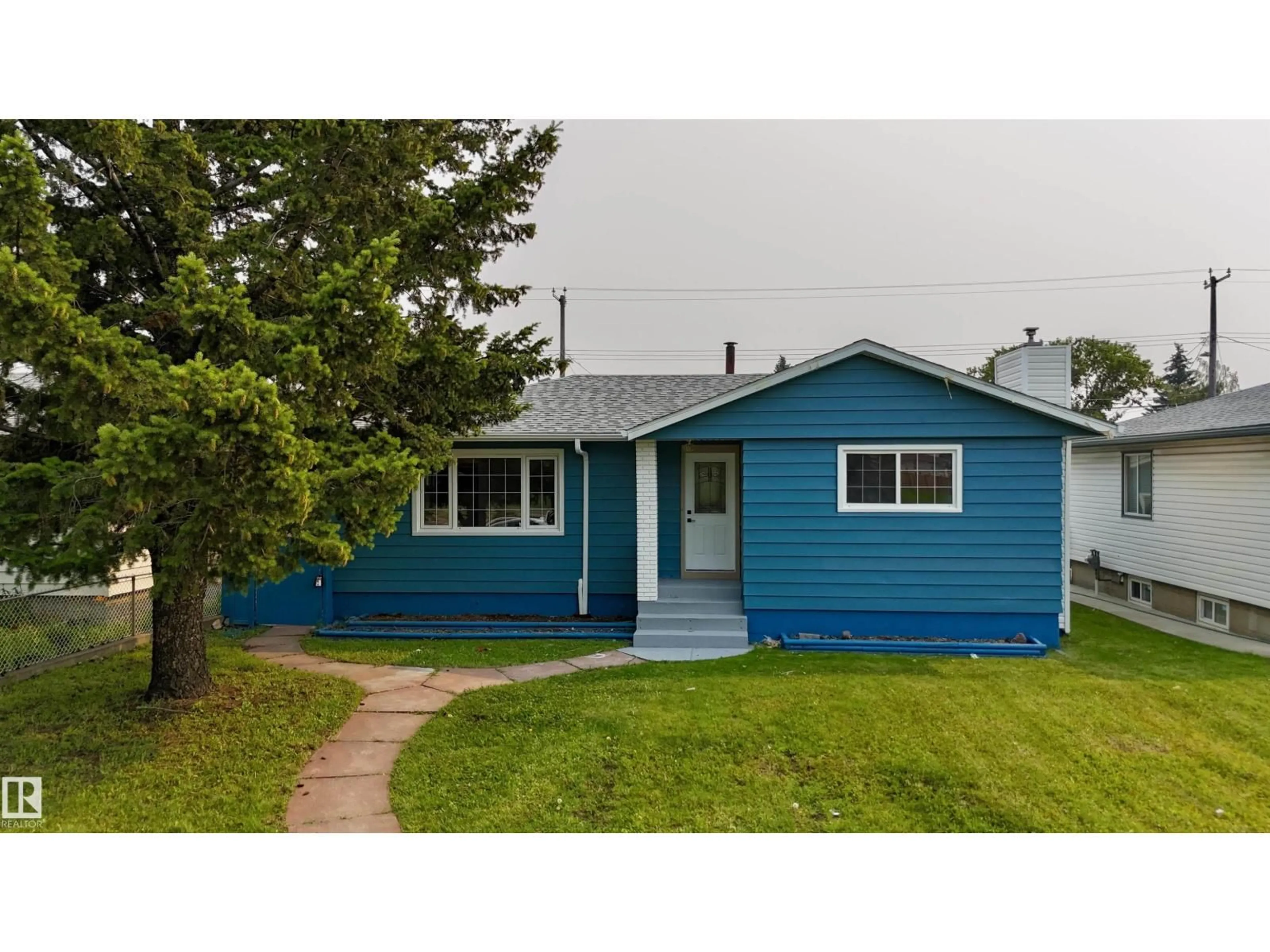Home with vinyl exterior material, street for 12023 137 AV, Edmonton Alberta T5E1Z7