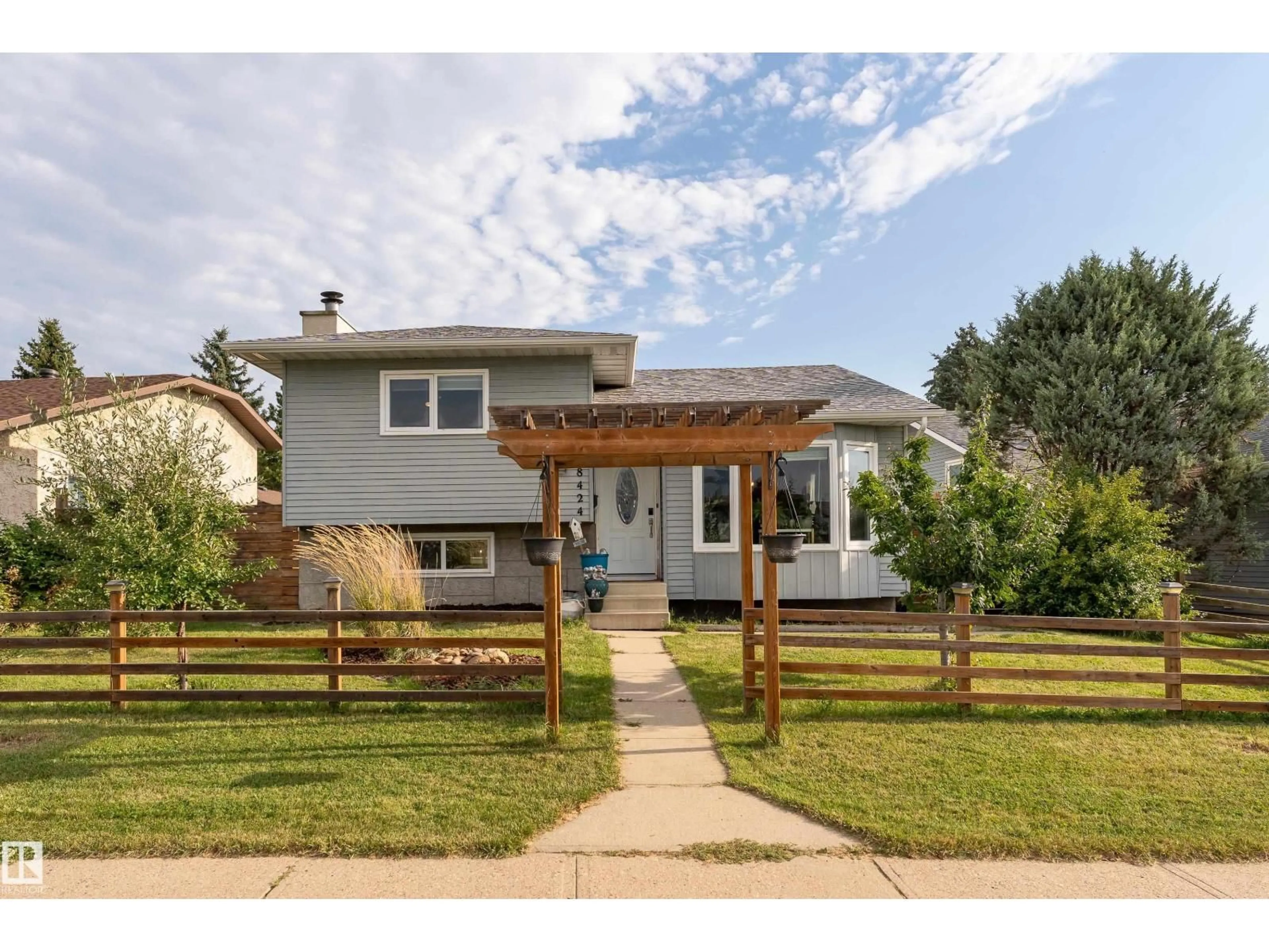 Home with vinyl exterior material, street for 18424 57 AV, Edmonton Alberta T6M1Y2