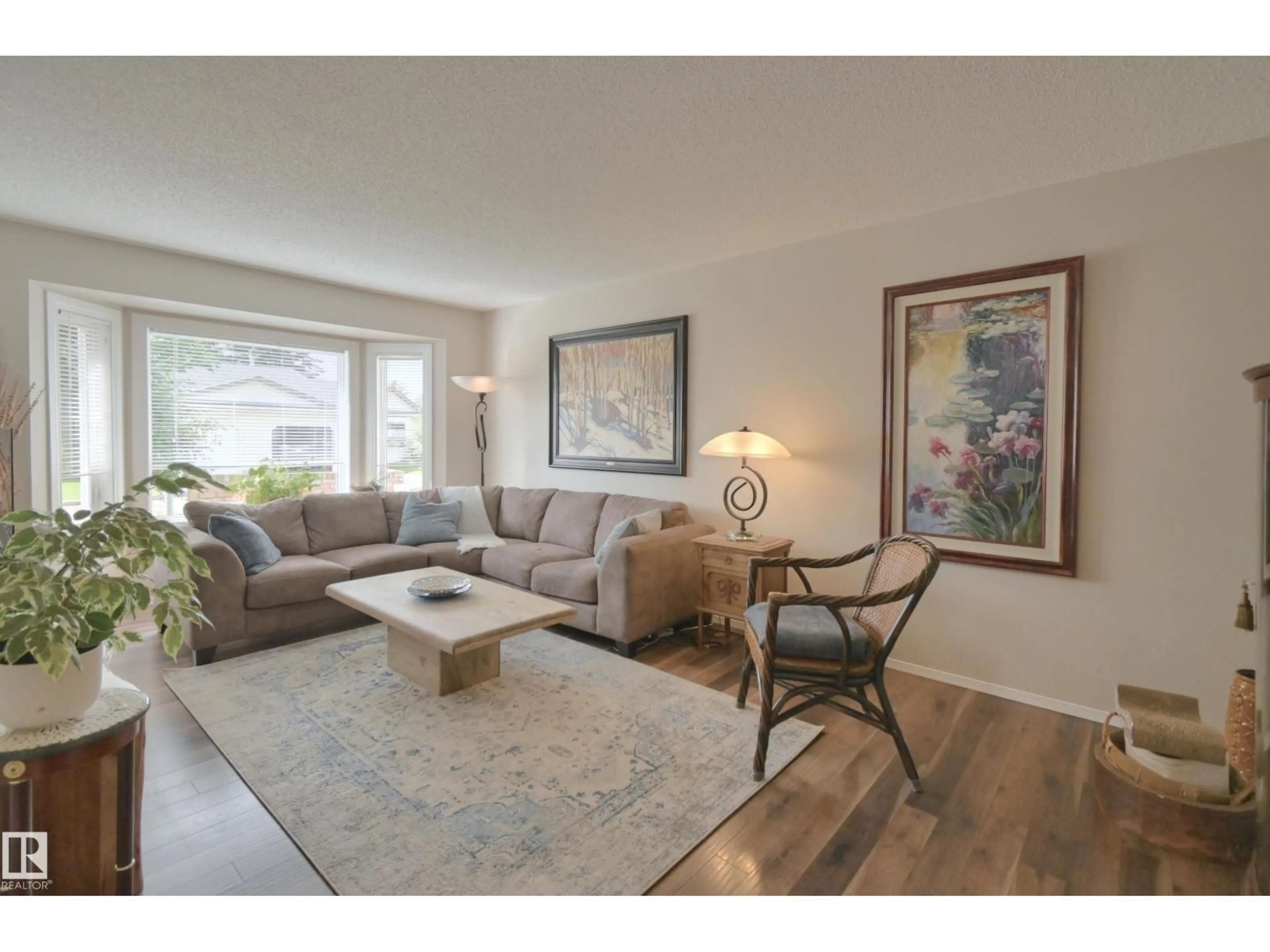 Living room with furniture, wood/laminate floor for NW - 5751 189 ST, Edmonton Alberta T6M2G8