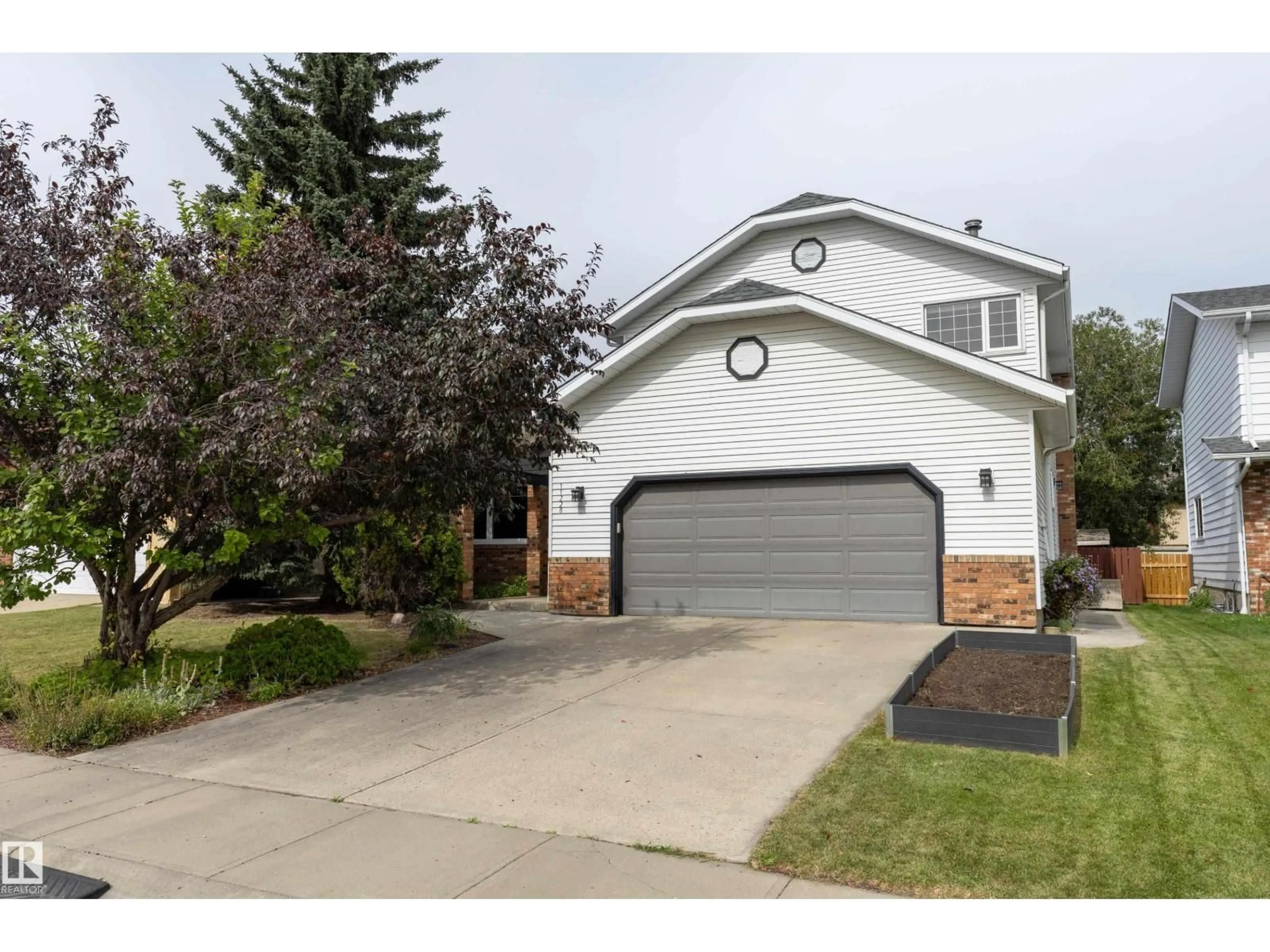 Home with vinyl exterior material, street for NW - 11220 23A AV, Edmonton Alberta T6J4X7