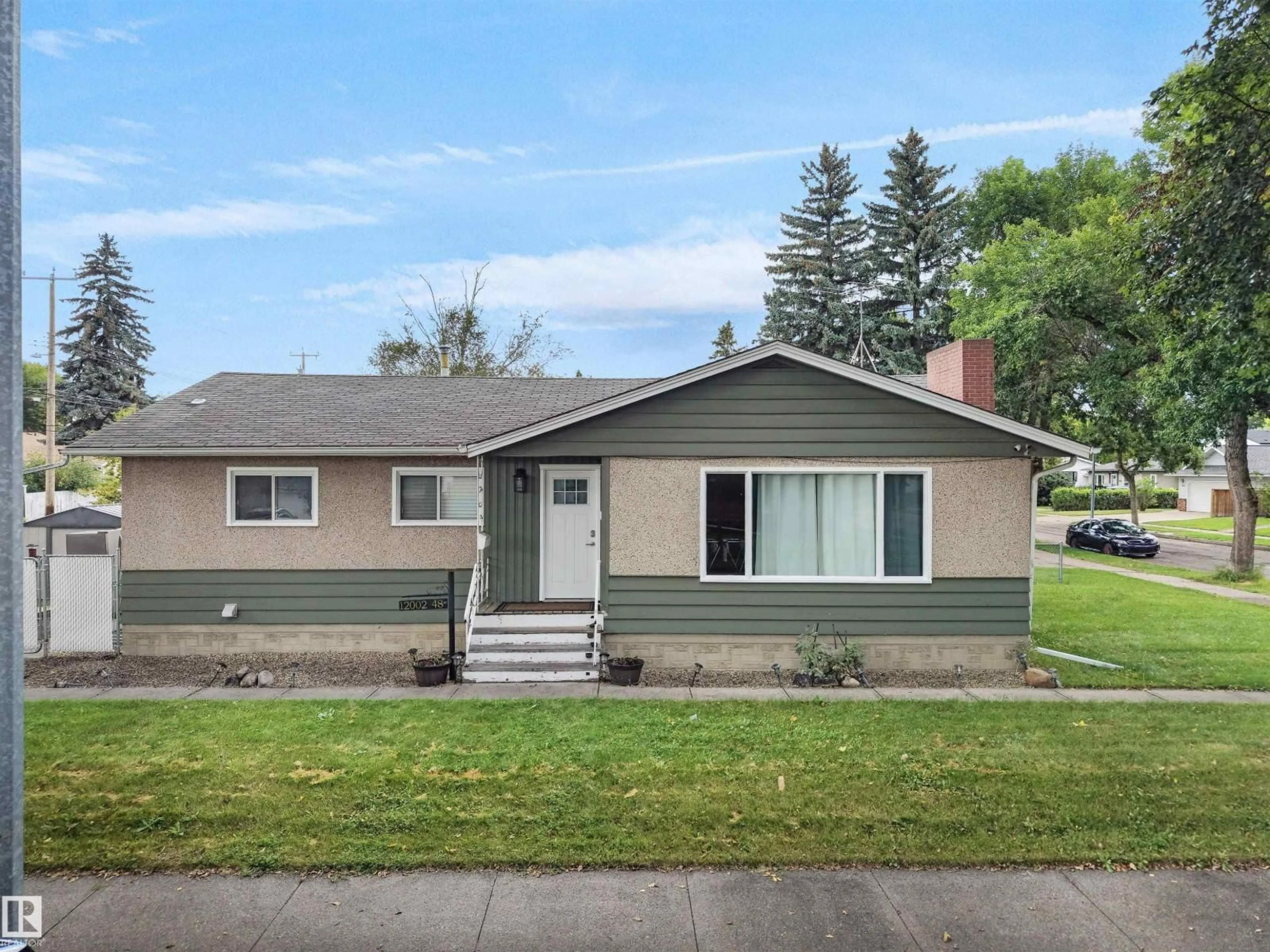 Home with vinyl exterior material, street for NW - 12002 48 ST, Edmonton Alberta T5W2Y8