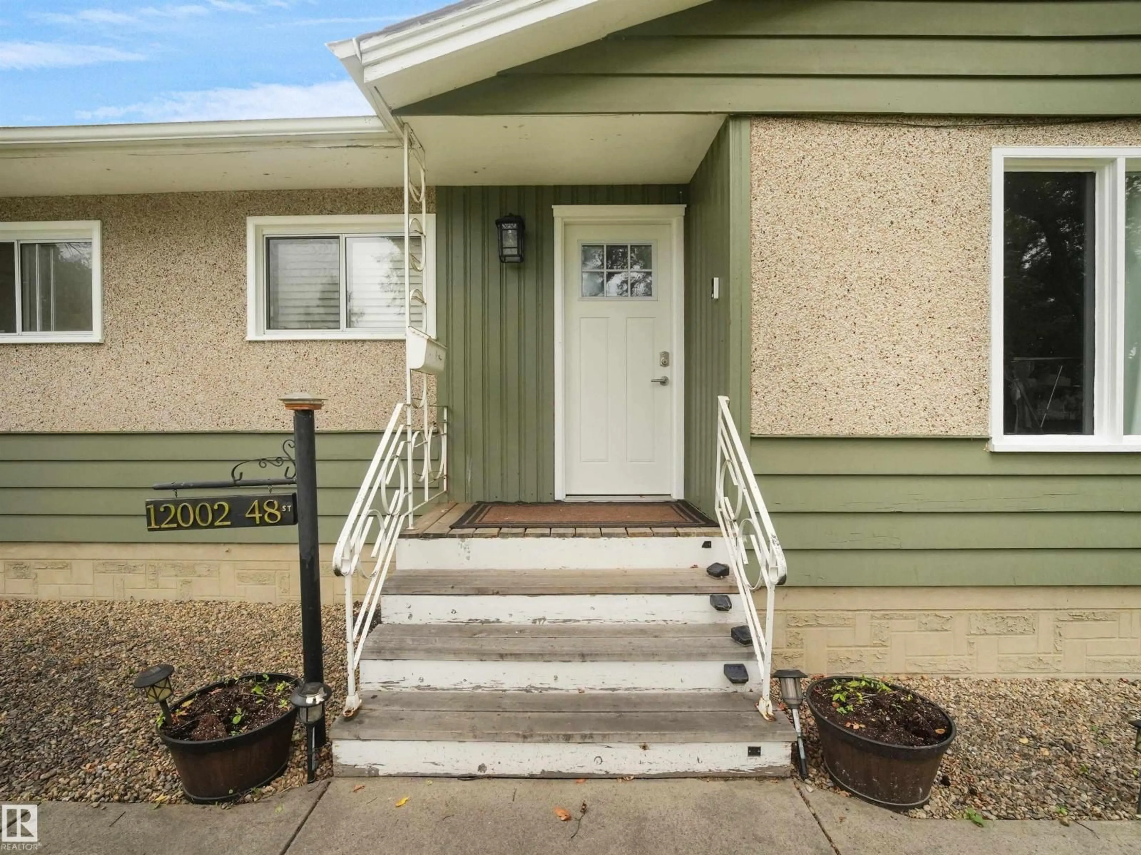 Home with vinyl exterior material, street for NW - 12002 48 ST, Edmonton Alberta T5W2Y8