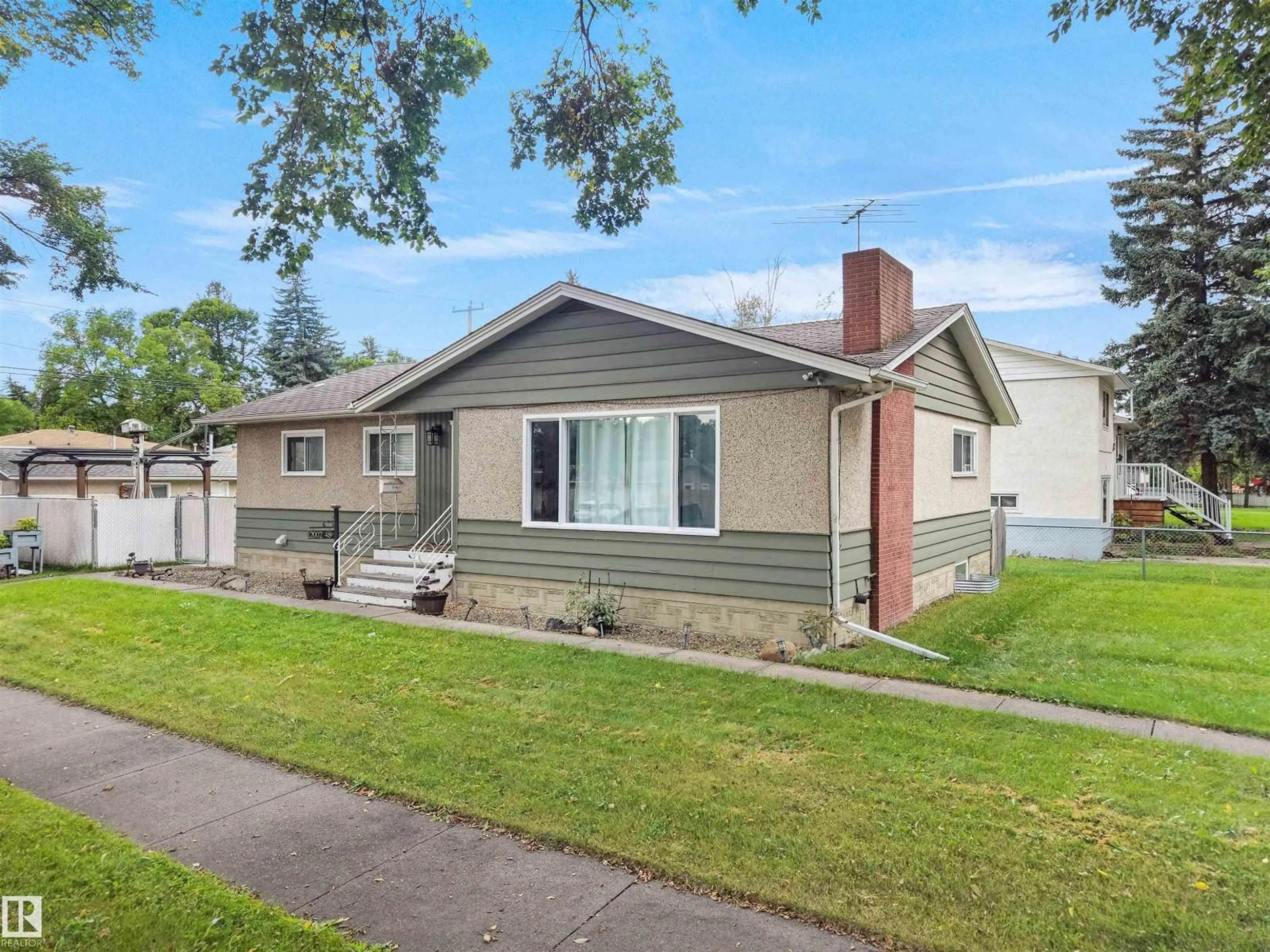 Home with vinyl exterior material, street for NW - 12002 48 ST, Edmonton Alberta T5W2Y8