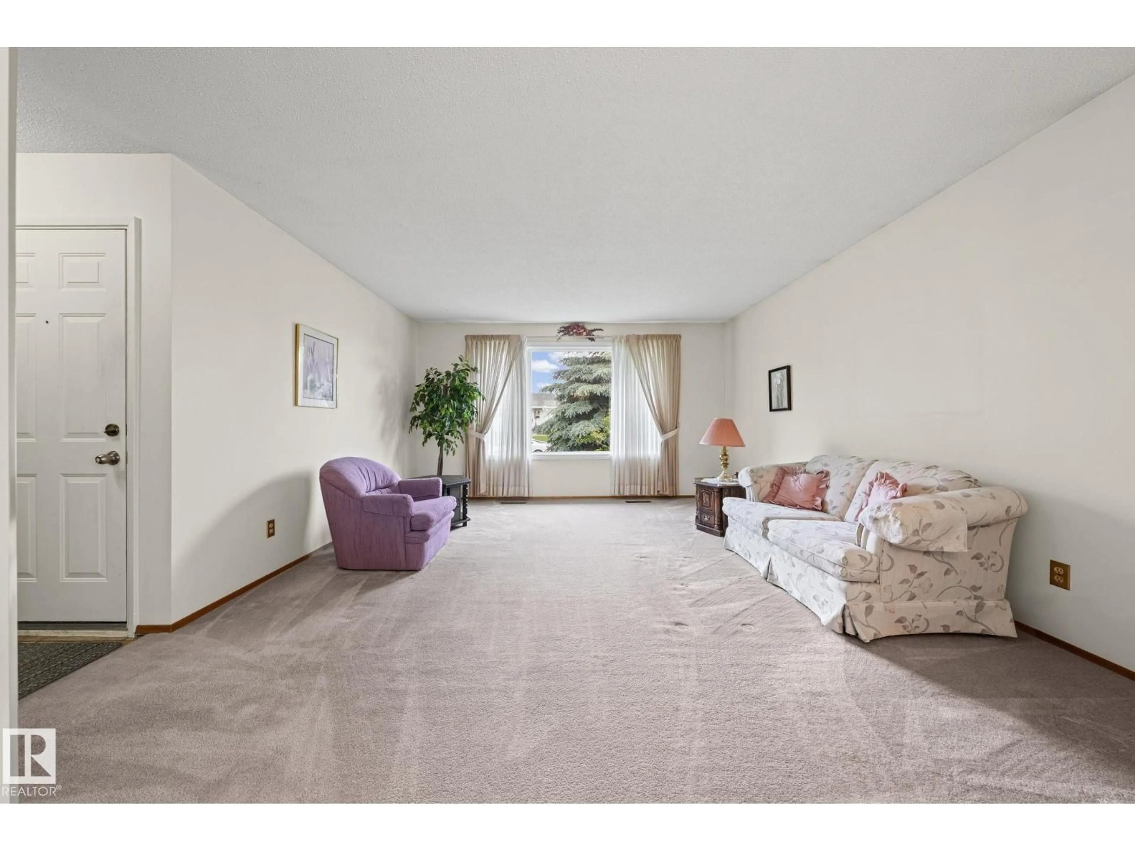 Living room with furniture, unknown for 8323 142 AV, Edmonton Alberta T5E2G3