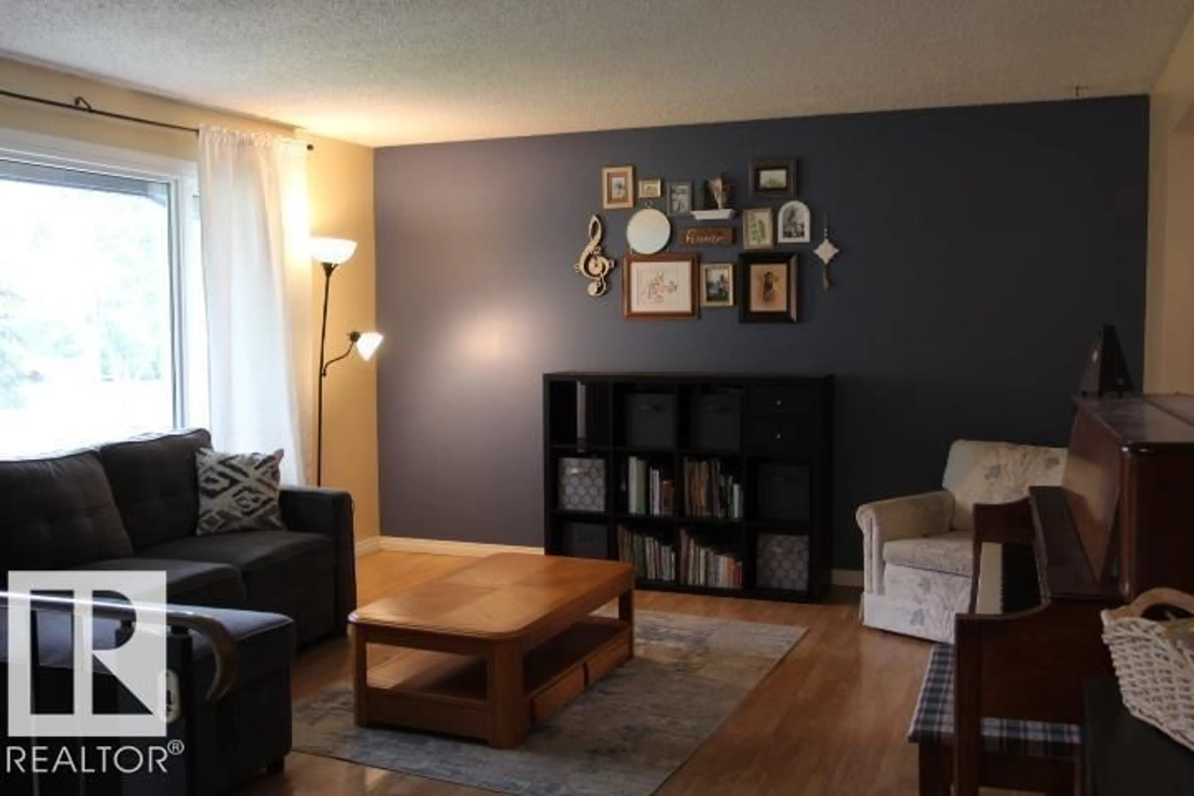Living room with furniture, wood/laminate floor for 64 APACHE CR, Leduc Alberta T9E4H4