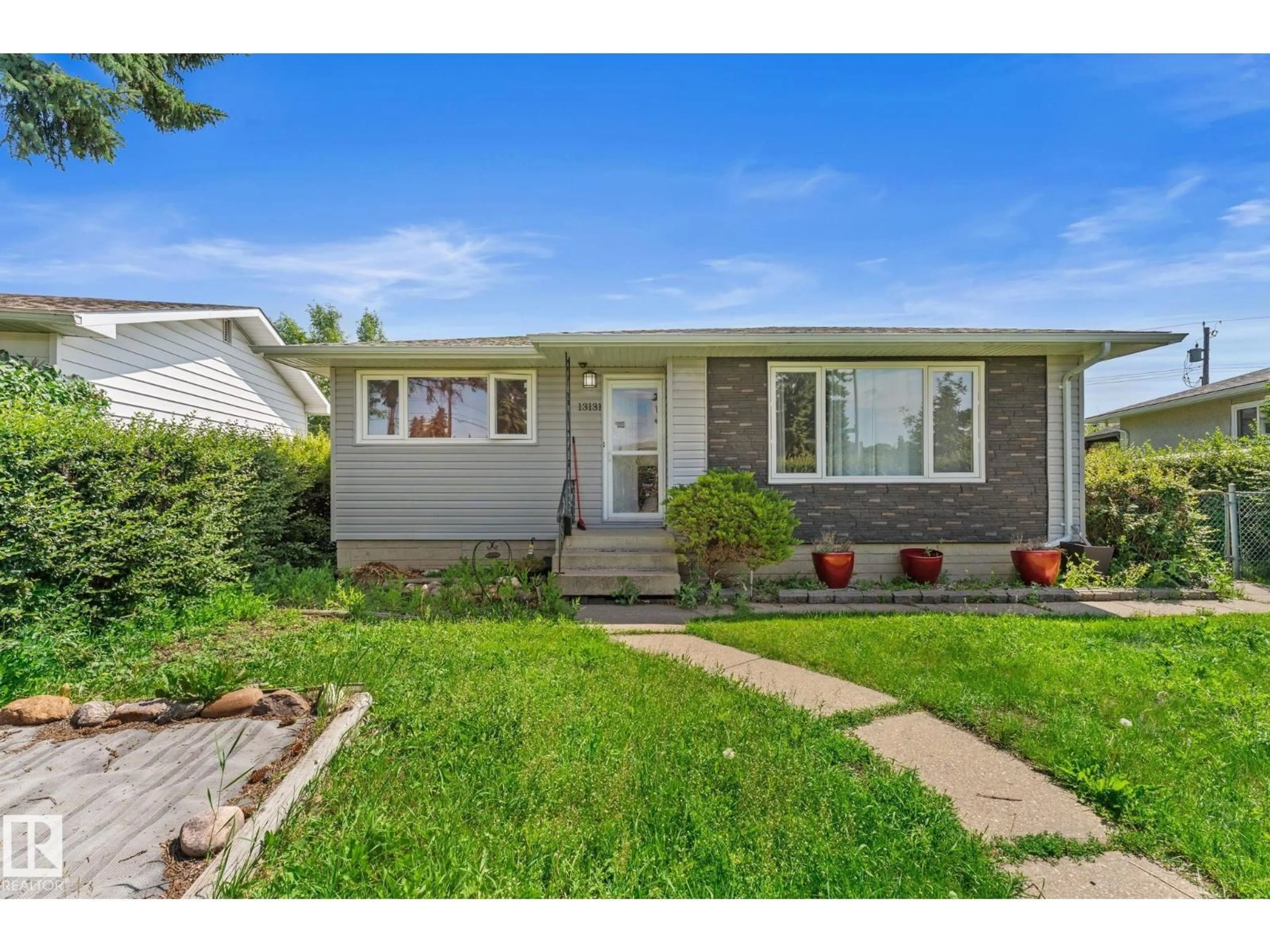 Home with vinyl exterior material, street for 13131 60 STREET, Edmonton Alberta T5A0S2