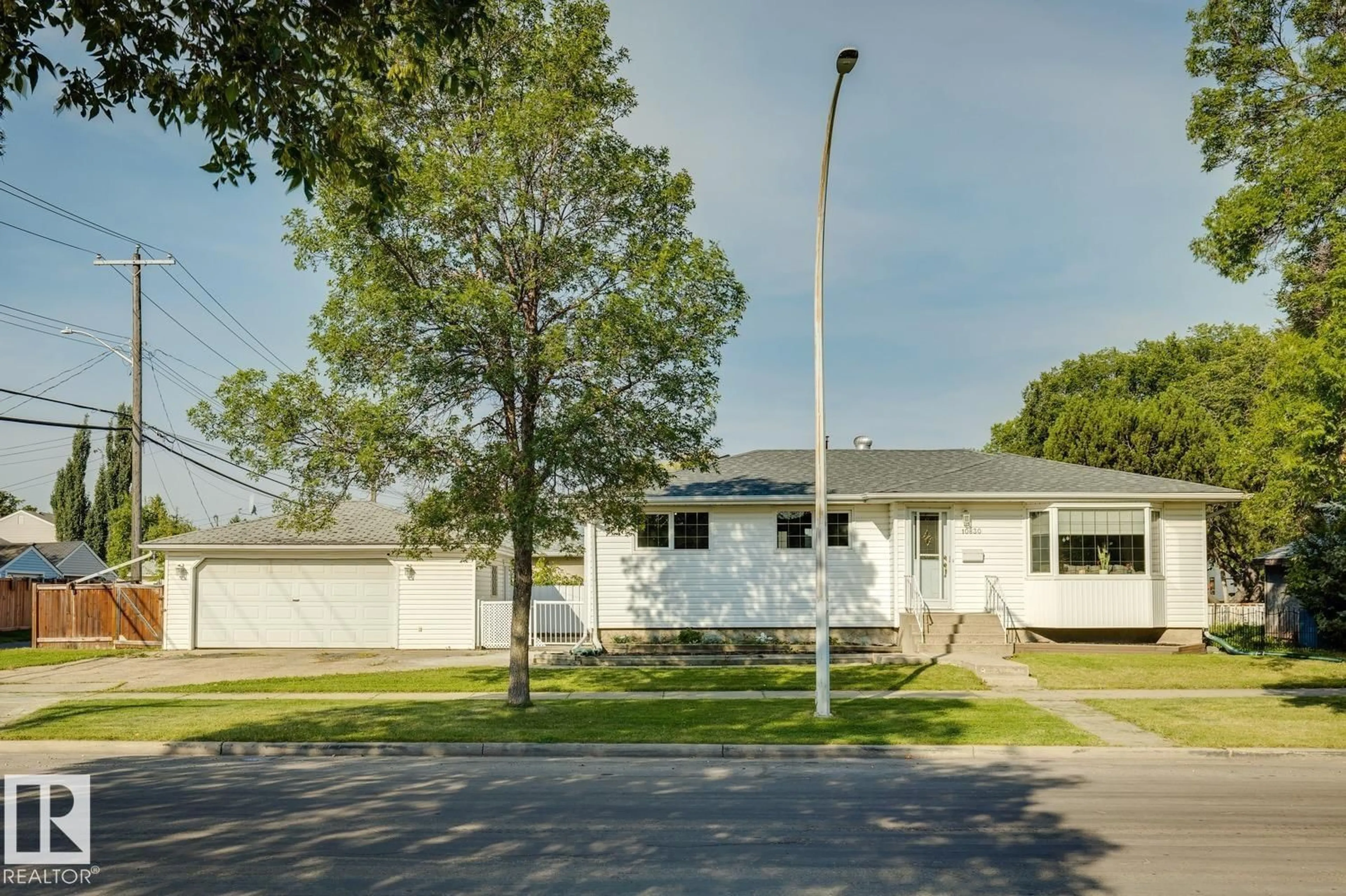 Home with vinyl exterior material, street for NW - 10830 159 ST, Edmonton Alberta T5P3B7
