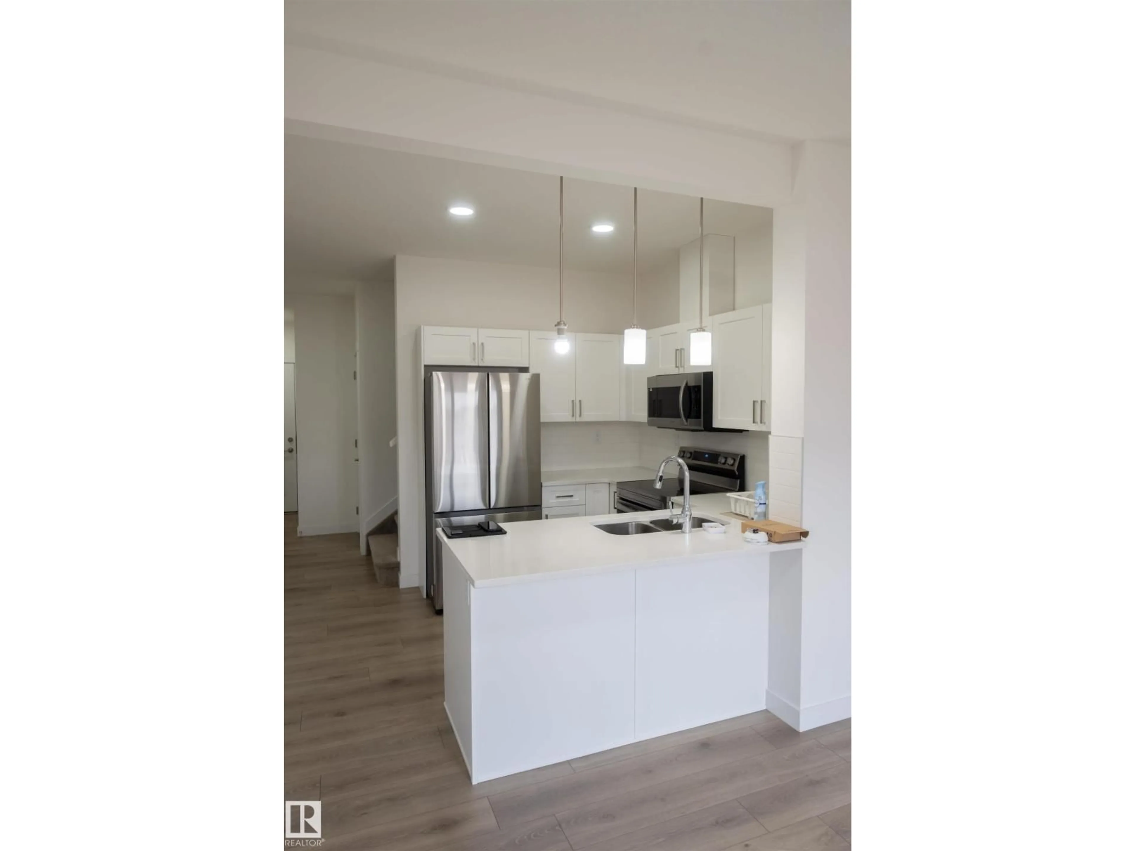 Open concept kitchen, wood/laminate floor for SW - 64 2710 66 ST, Edmonton Alberta T6X3H4