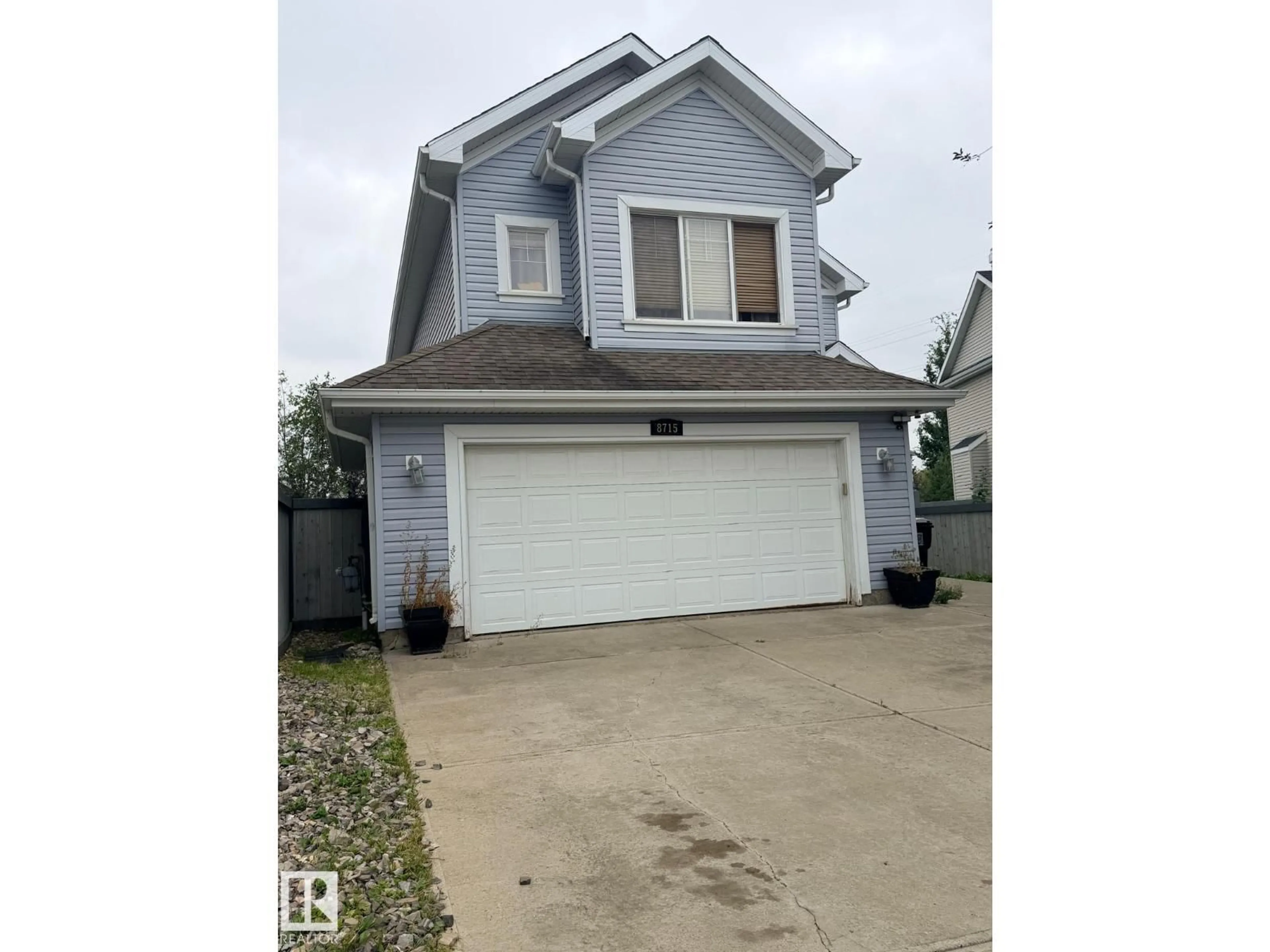Home with vinyl exterior material, street for 8715 11 AV SW, Edmonton Alberta T6X1J5