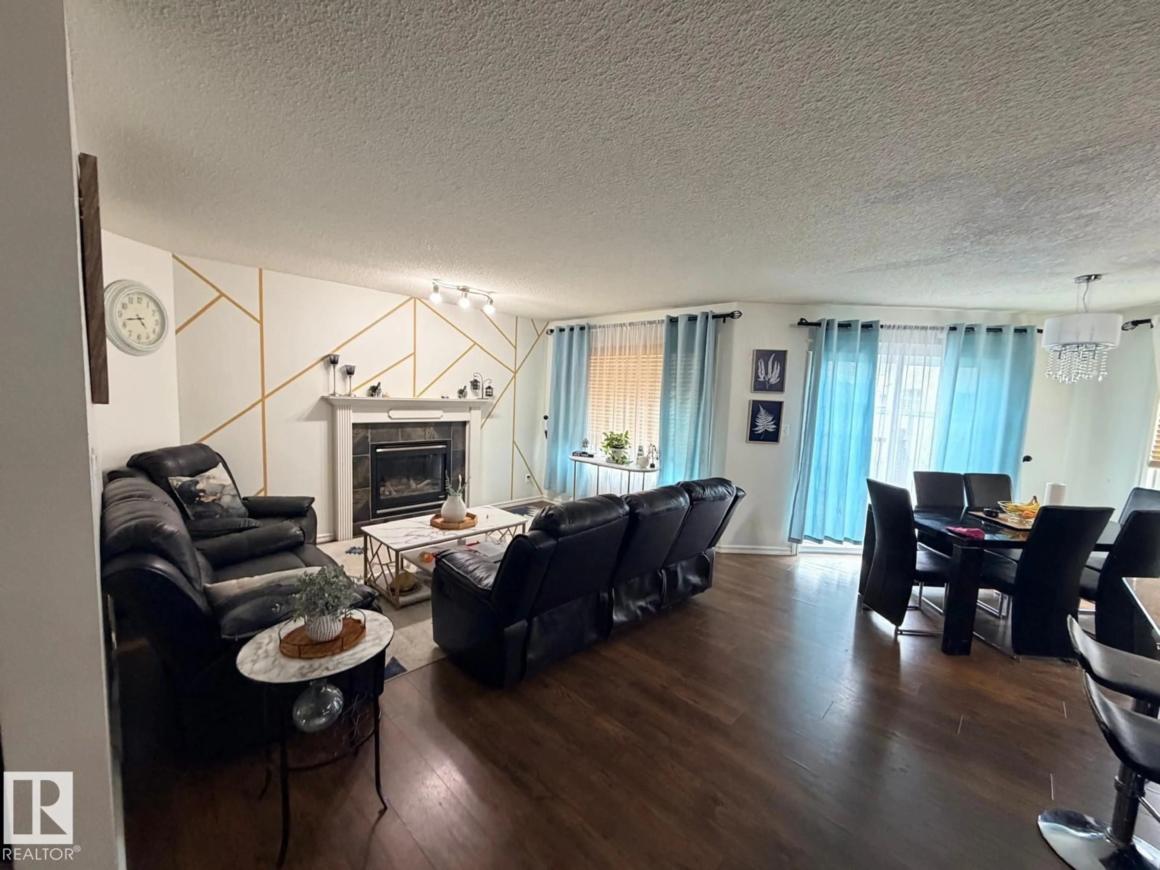 Living room with furniture, wood/laminate floor for 8715 11 AV SW, Edmonton Alberta T6X1J5