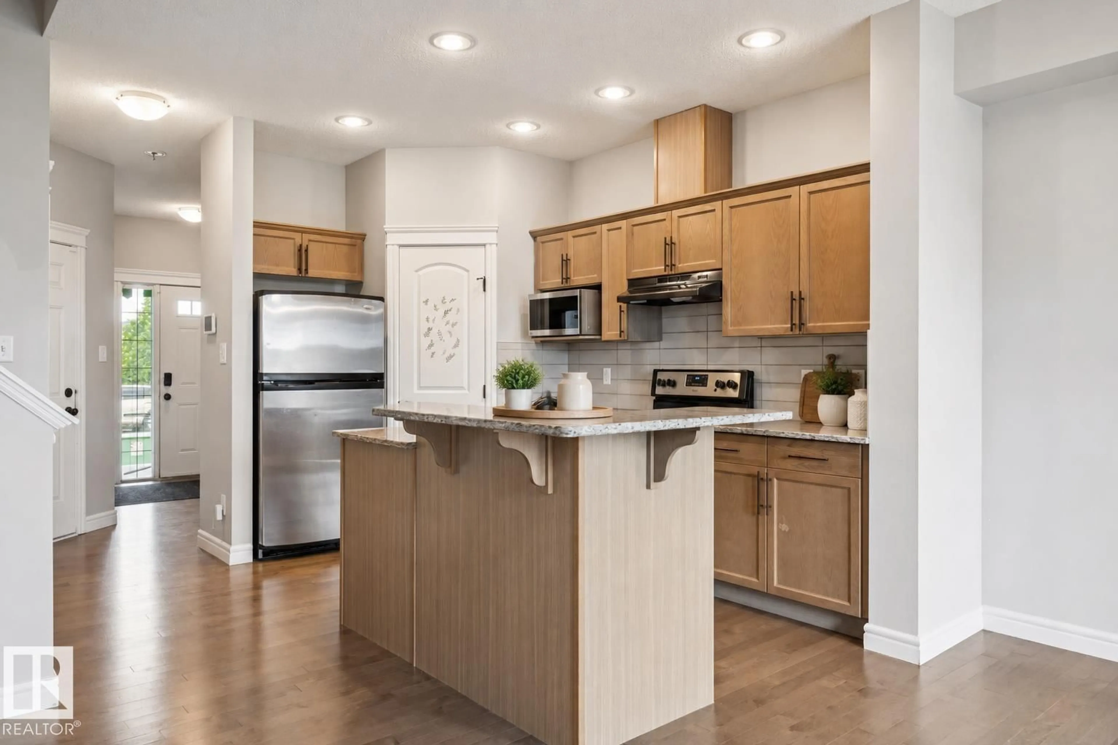 Open concept kitchen, wood/laminate floor for 17011 38 ST, Edmonton Alberta T5Y3S2