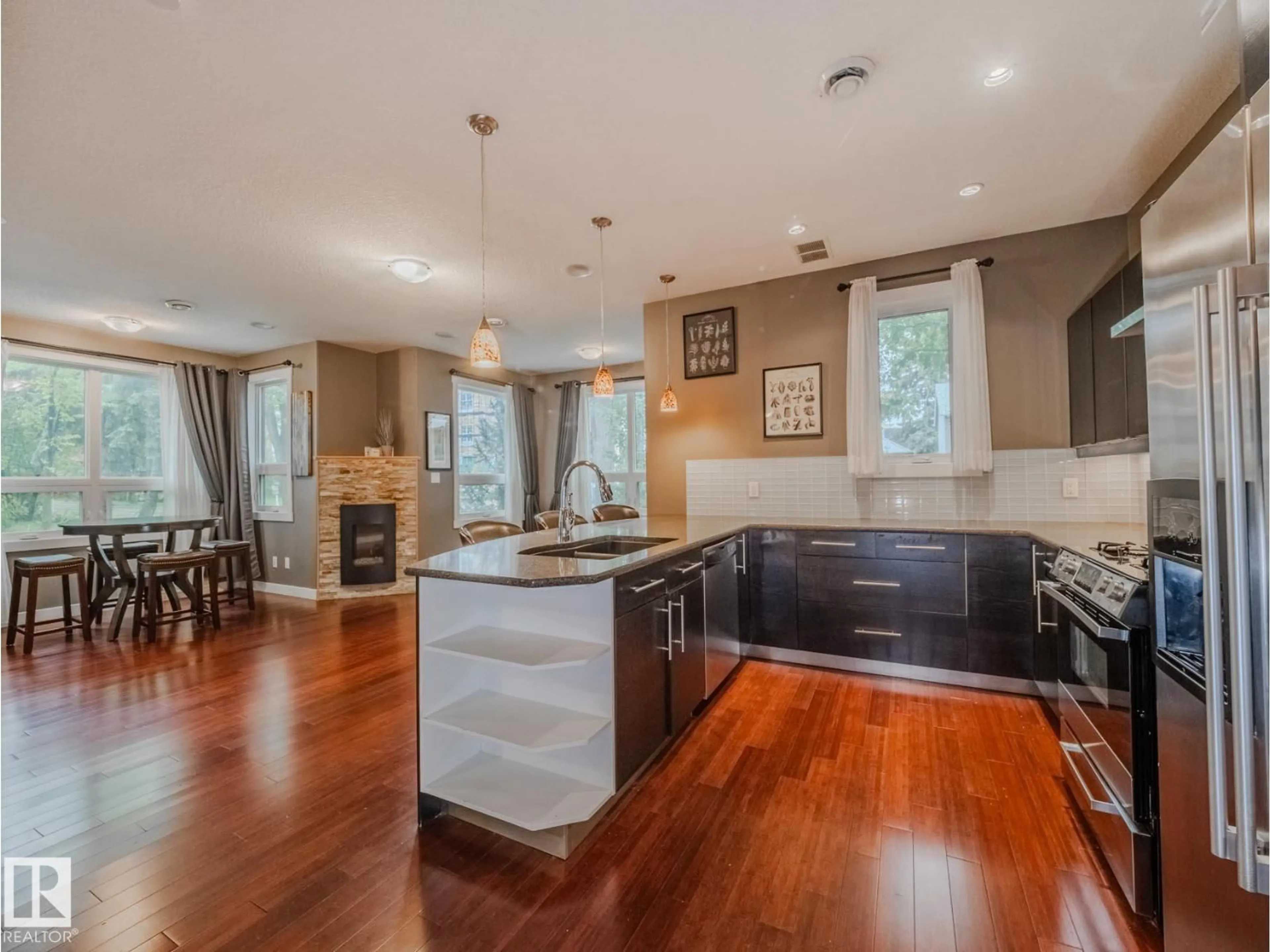 Open concept kitchen, wood/laminate floor for 8306 108 ST, Edmonton Alberta T6E2J1