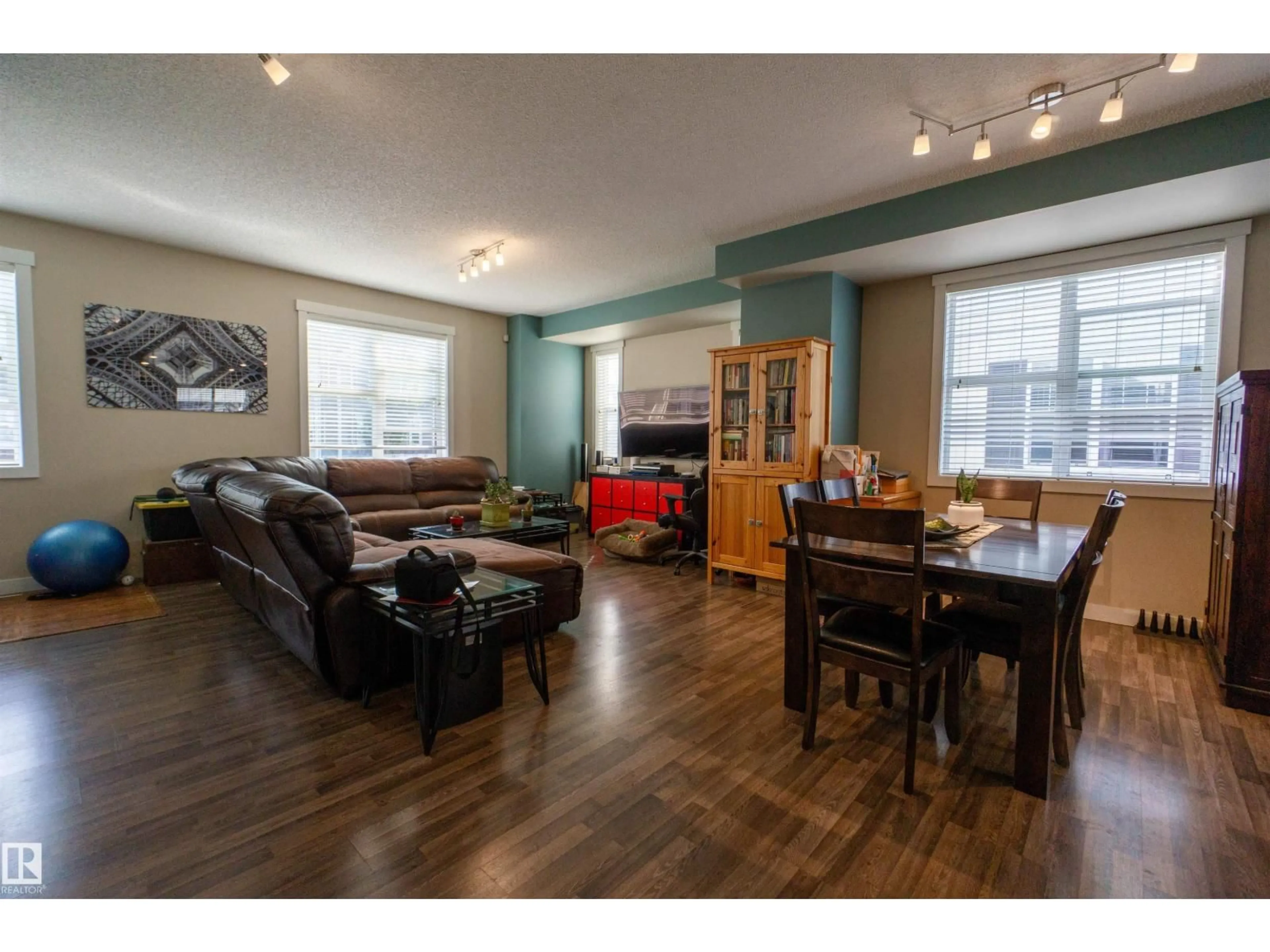 Living room with furniture, wood/laminate floor for 75 8315 180 AV NW, Edmonton Alberta T5Z0J2
