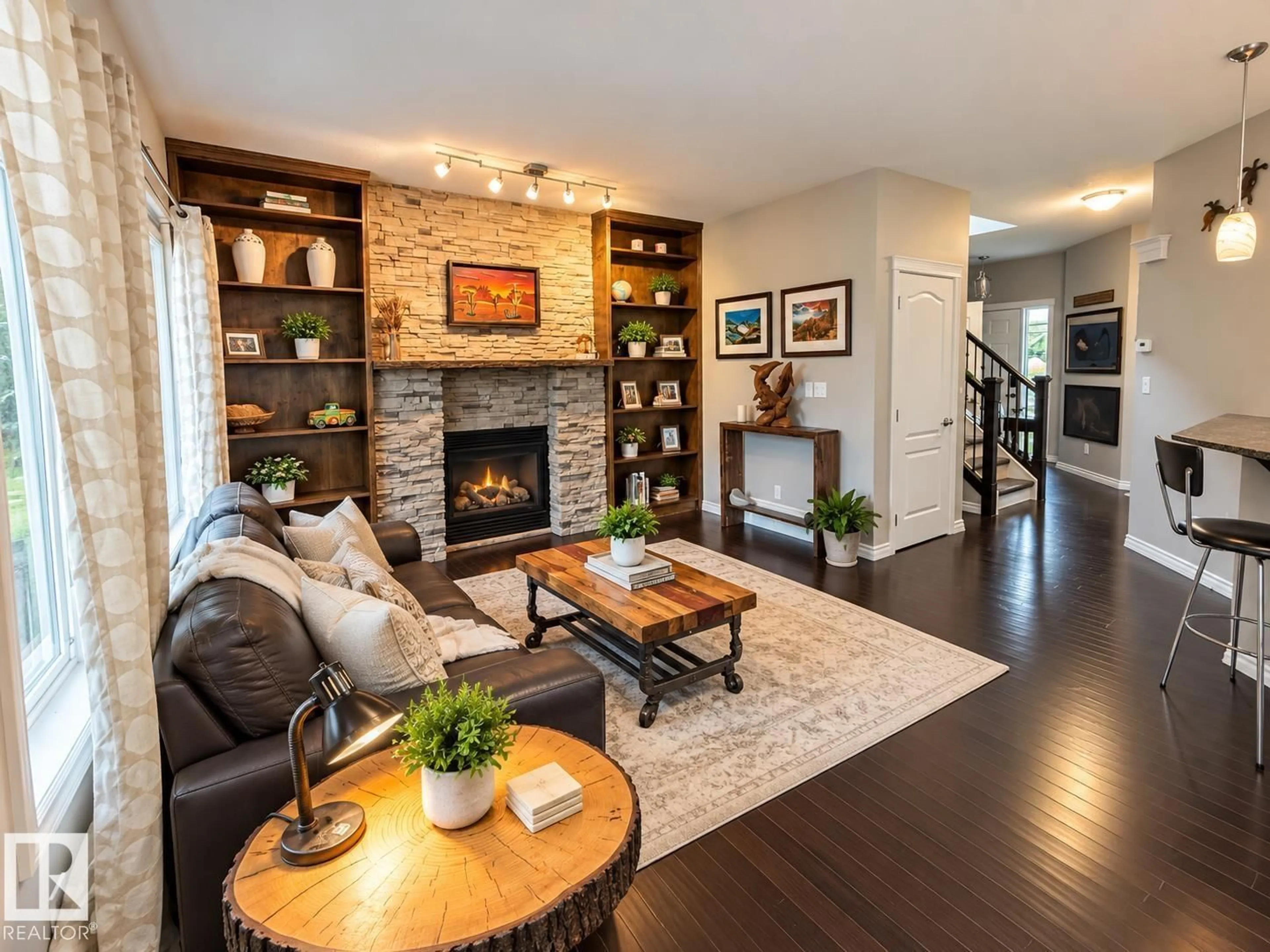 Living room with furniture, wood/laminate floor for 16893 58A ST, Edmonton Alberta T5Y0N1