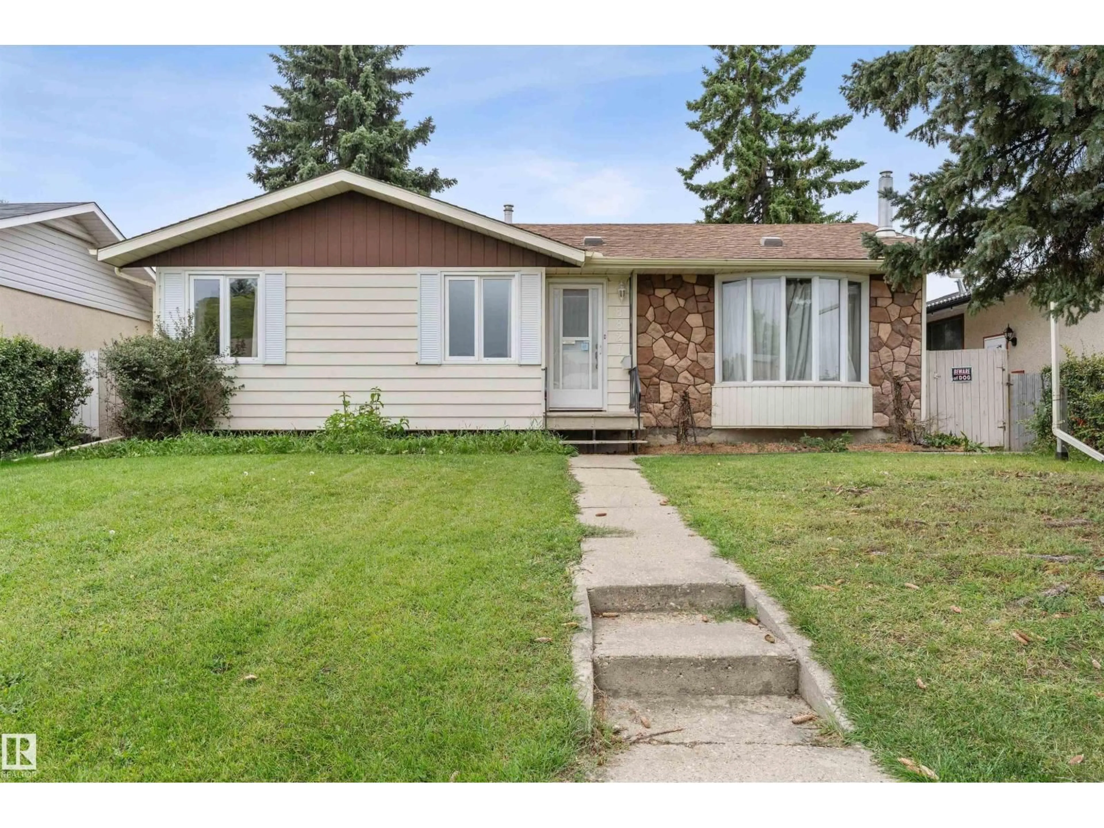 Home with vinyl exterior material, street for 8827 138 AV, Edmonton Alberta T5E2A7
