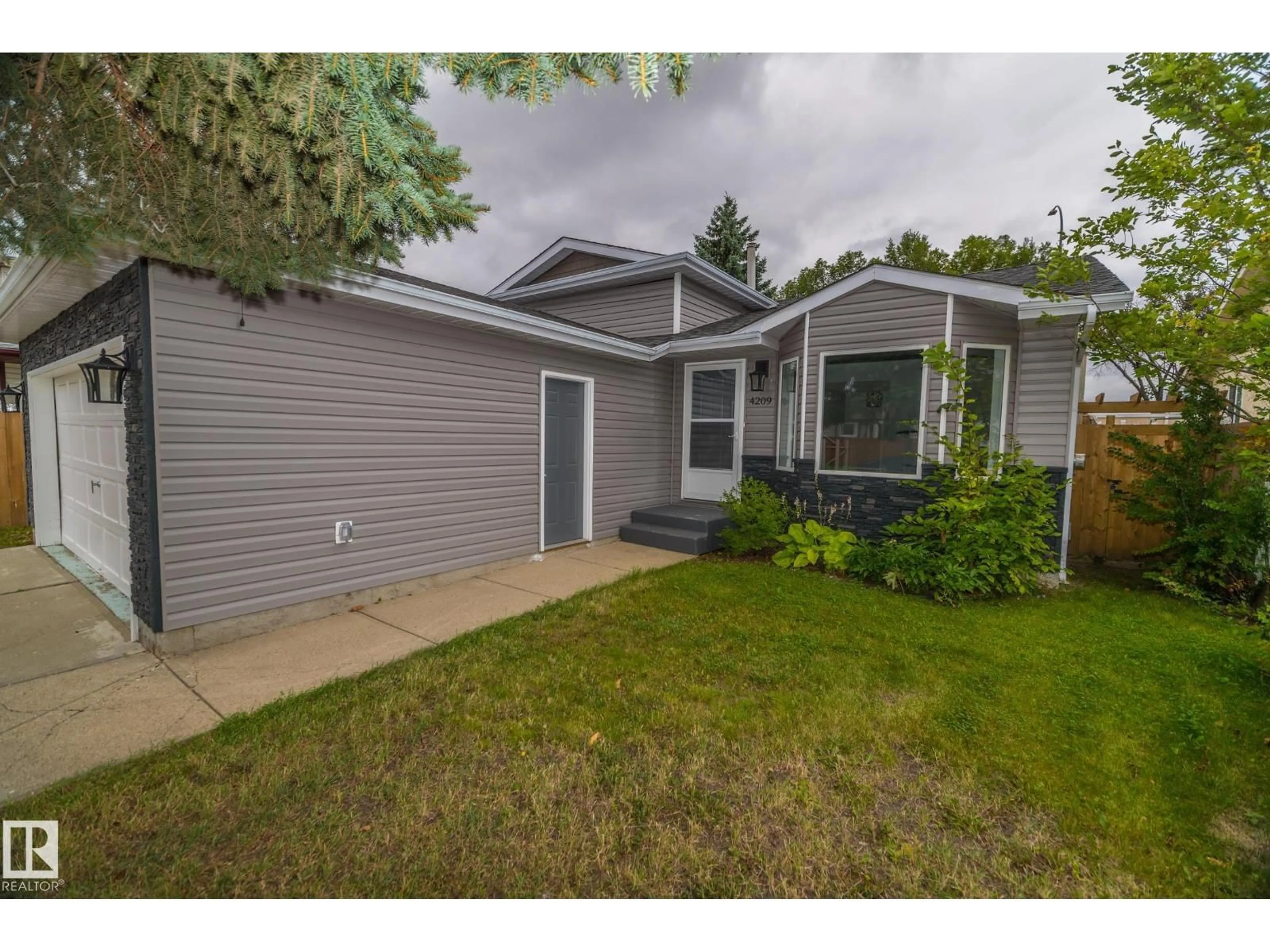 Home with vinyl exterior material, street for 4209 25 AV, Edmonton Alberta T6L6B4