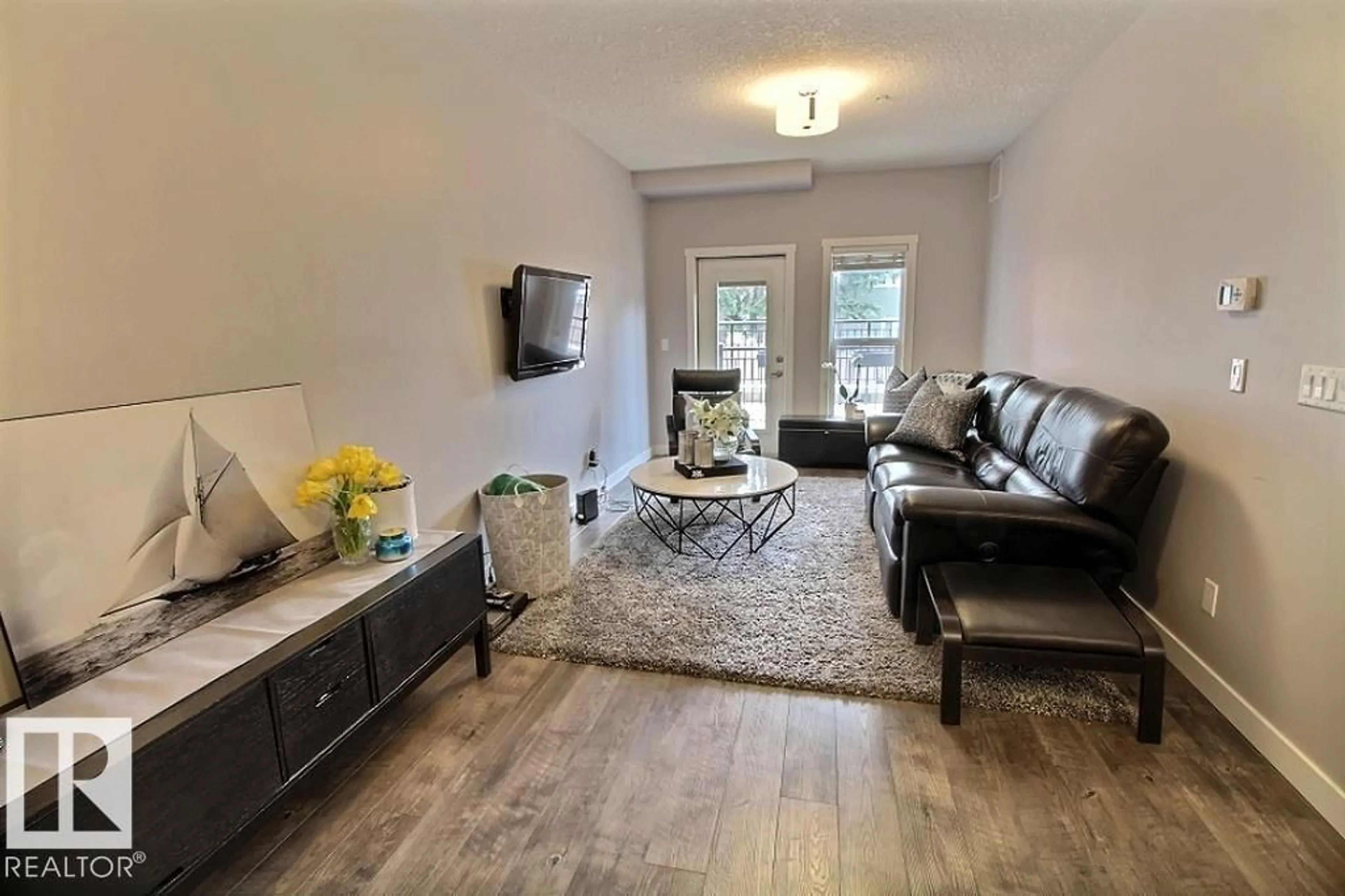 Living room with furniture, wood/laminate floor for #106 - 10126 144 ST, Edmonton Alberta T5N2T7