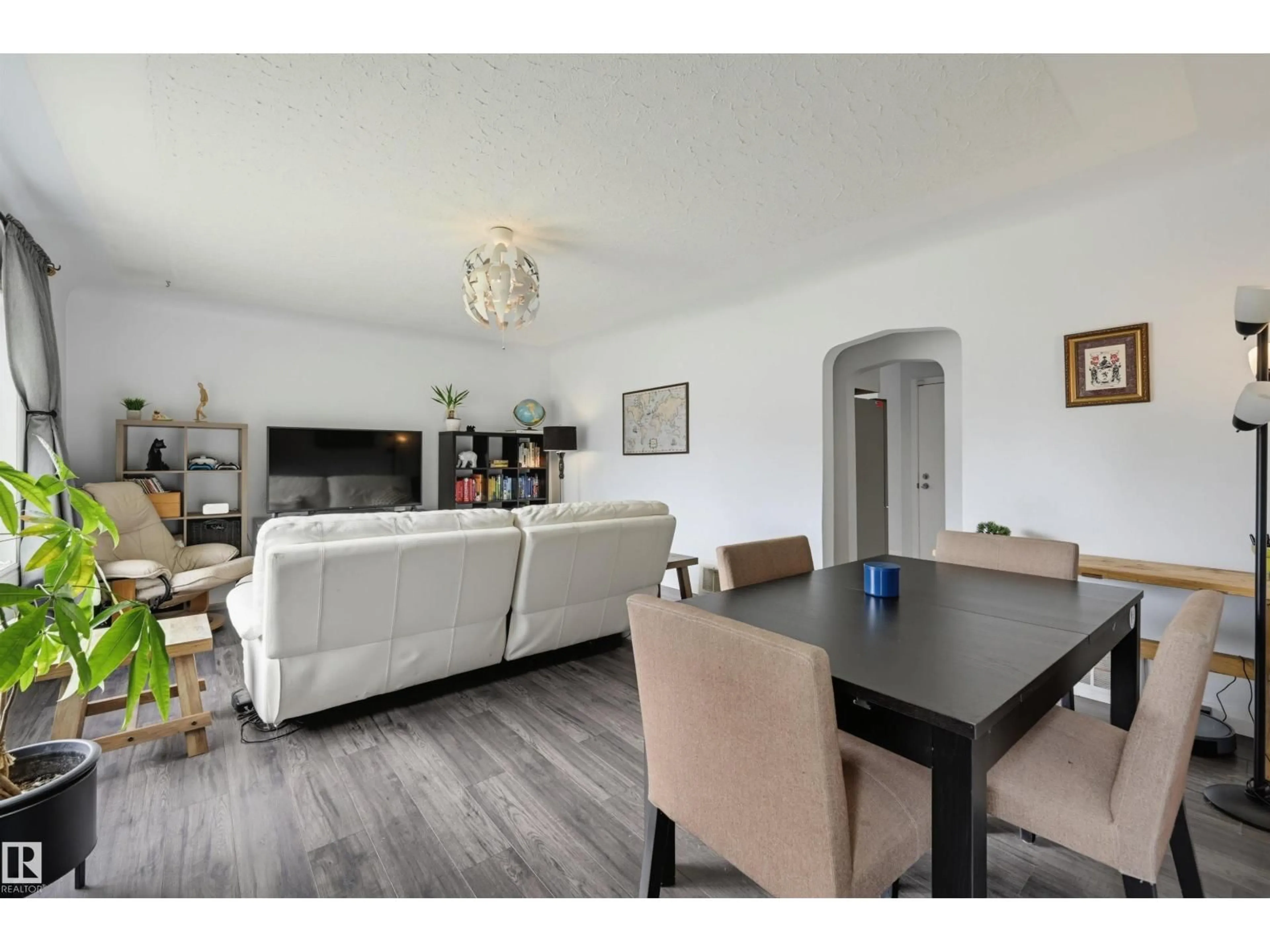 Living room with furniture, wood/laminate floor for 10670 61 AV, Edmonton Alberta T6H1L7