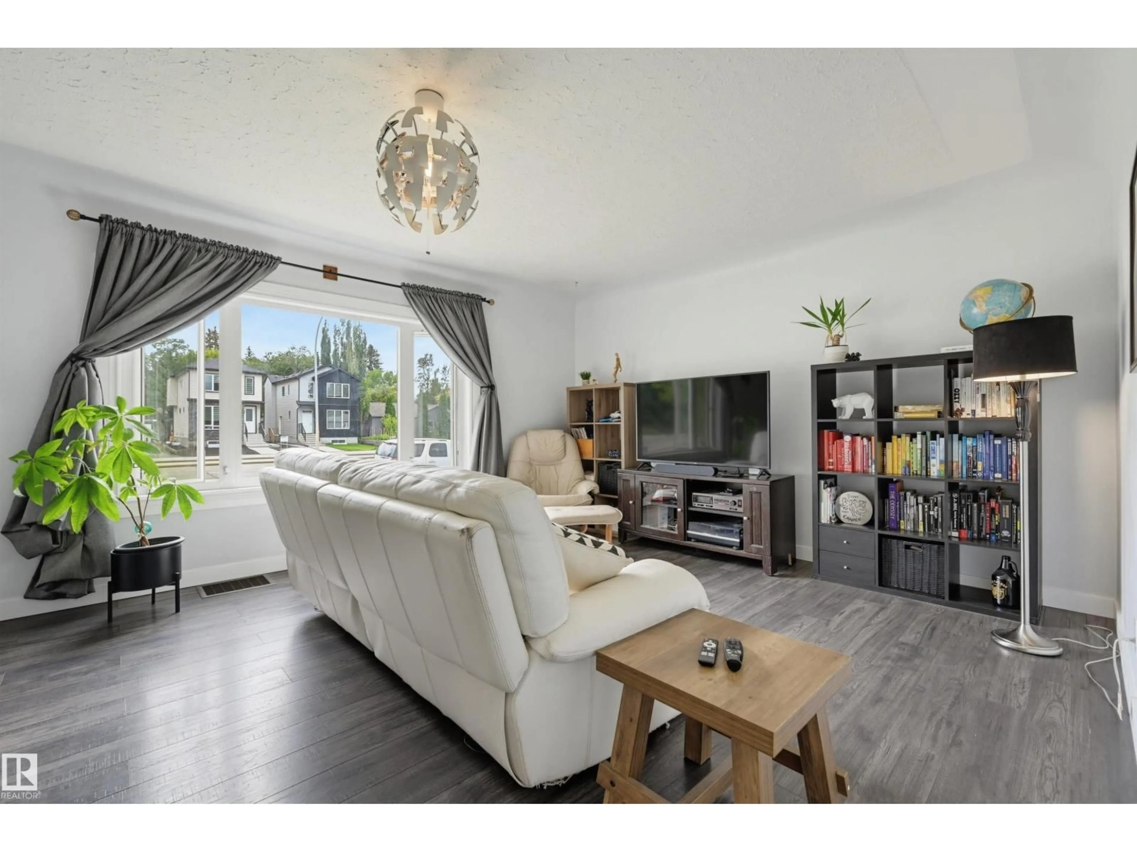 Living room with furniture, wood/laminate floor for 10670 61 AV, Edmonton Alberta T6H1L7
