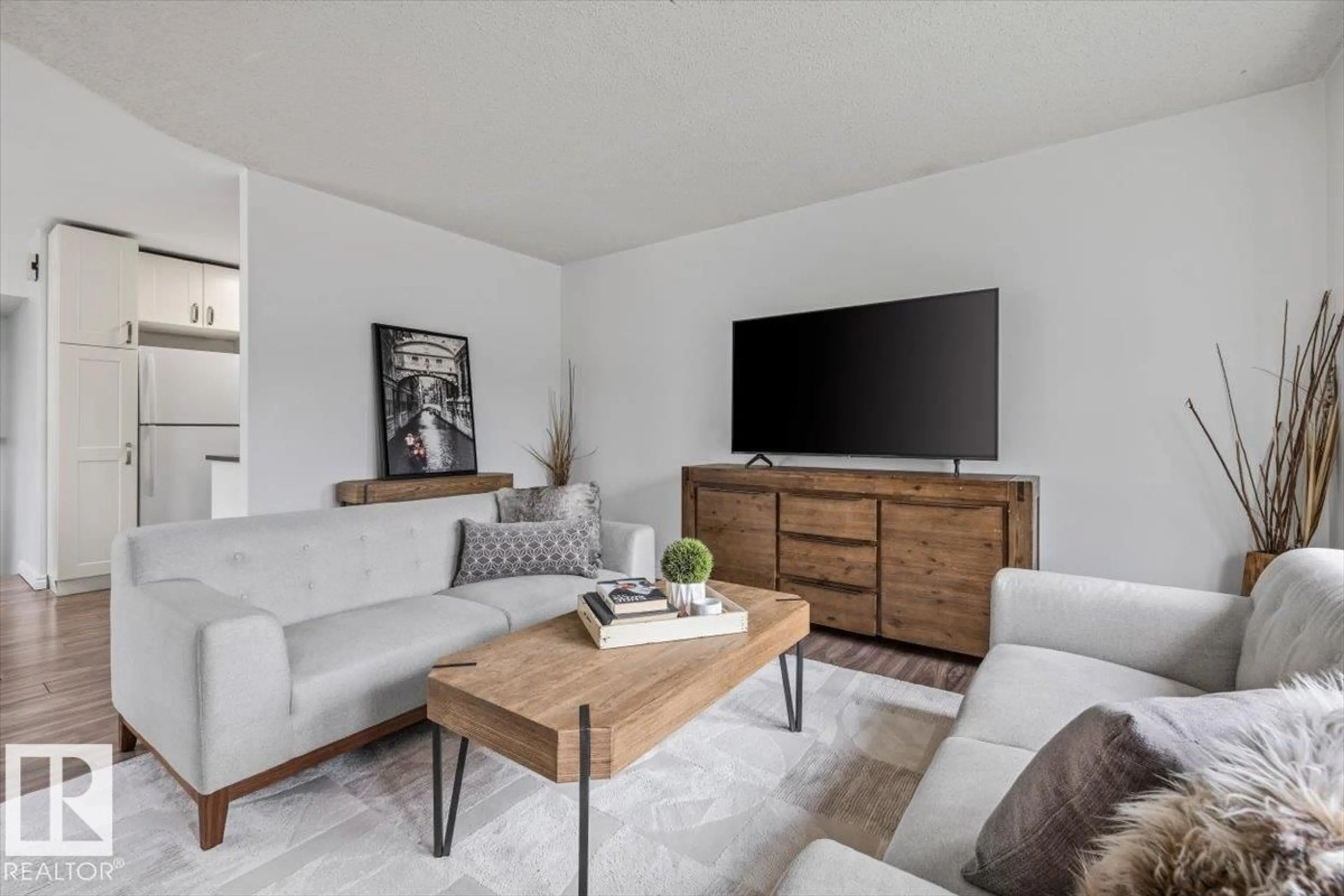Living room with furniture, wood/laminate floor for 18703 57 AV, Edmonton Alberta T6M2A6