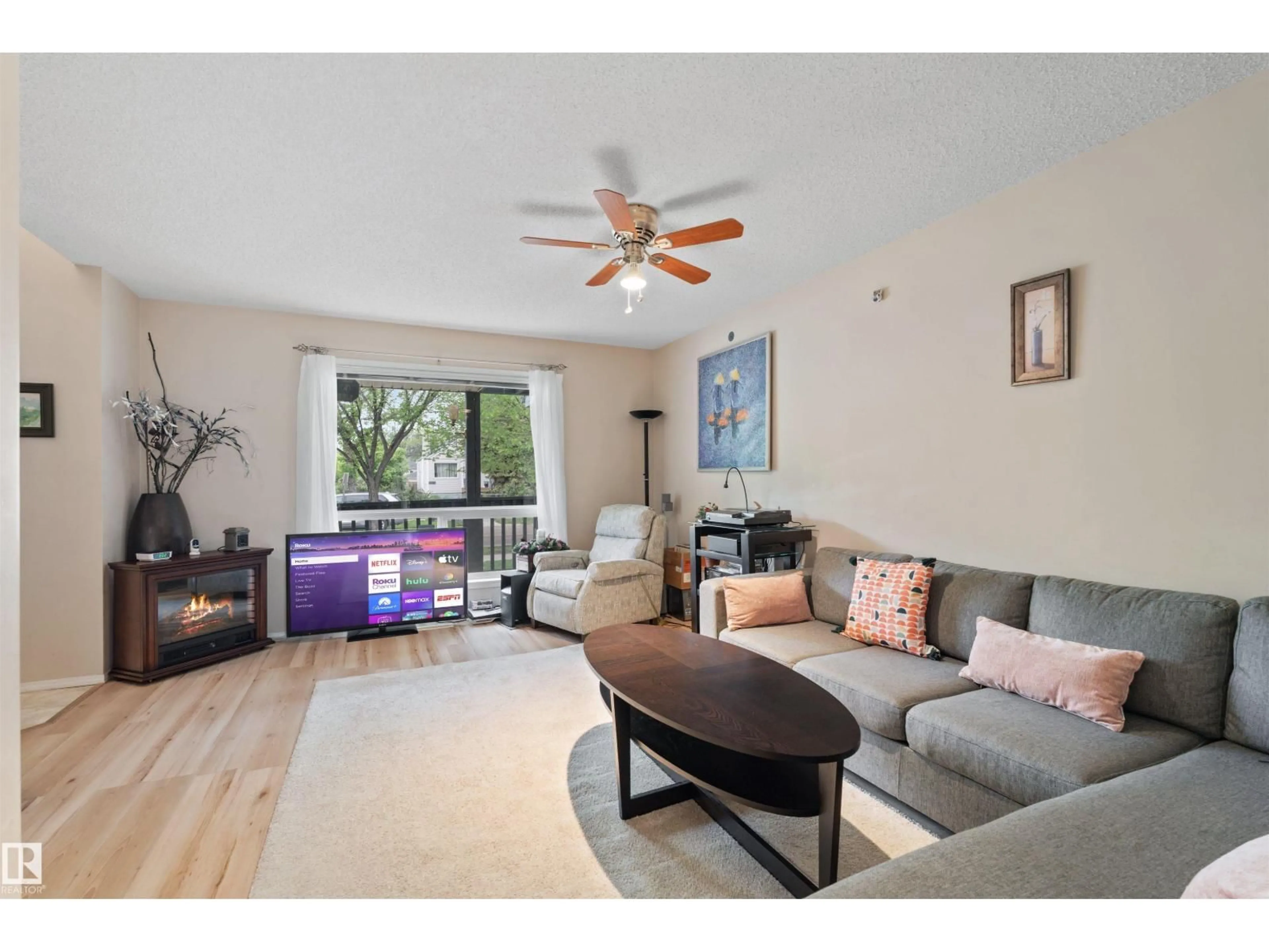 Living room with furniture, wood/laminate floor for 10909 106 ST NW, Edmonton Alberta T5H4M7