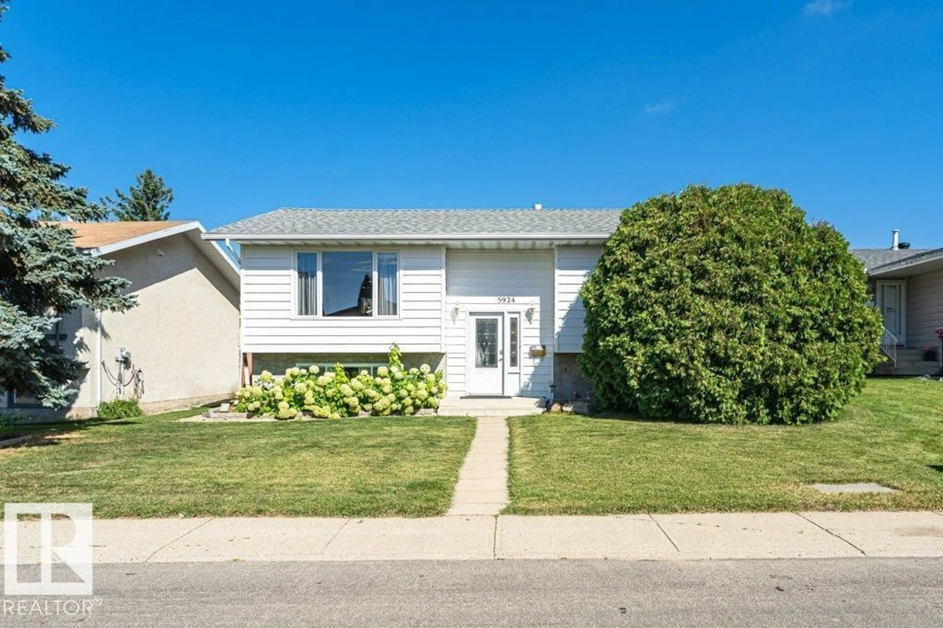 Home with vinyl exterior material, street for 5924 11 AV, Edmonton Alberta T6L3A6