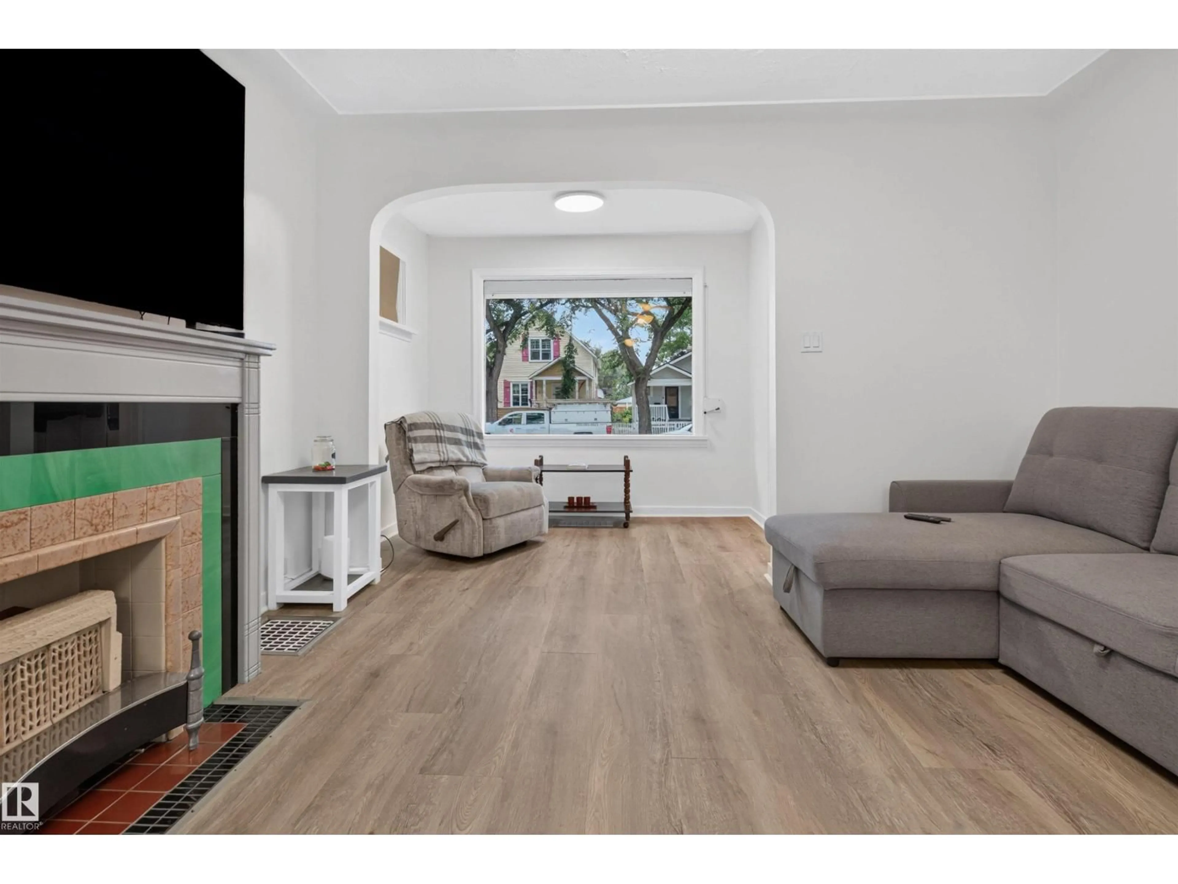 Living room with furniture, wood/laminate floor for NW - 11431 88 ST, Edmonton Alberta T5B3P9
