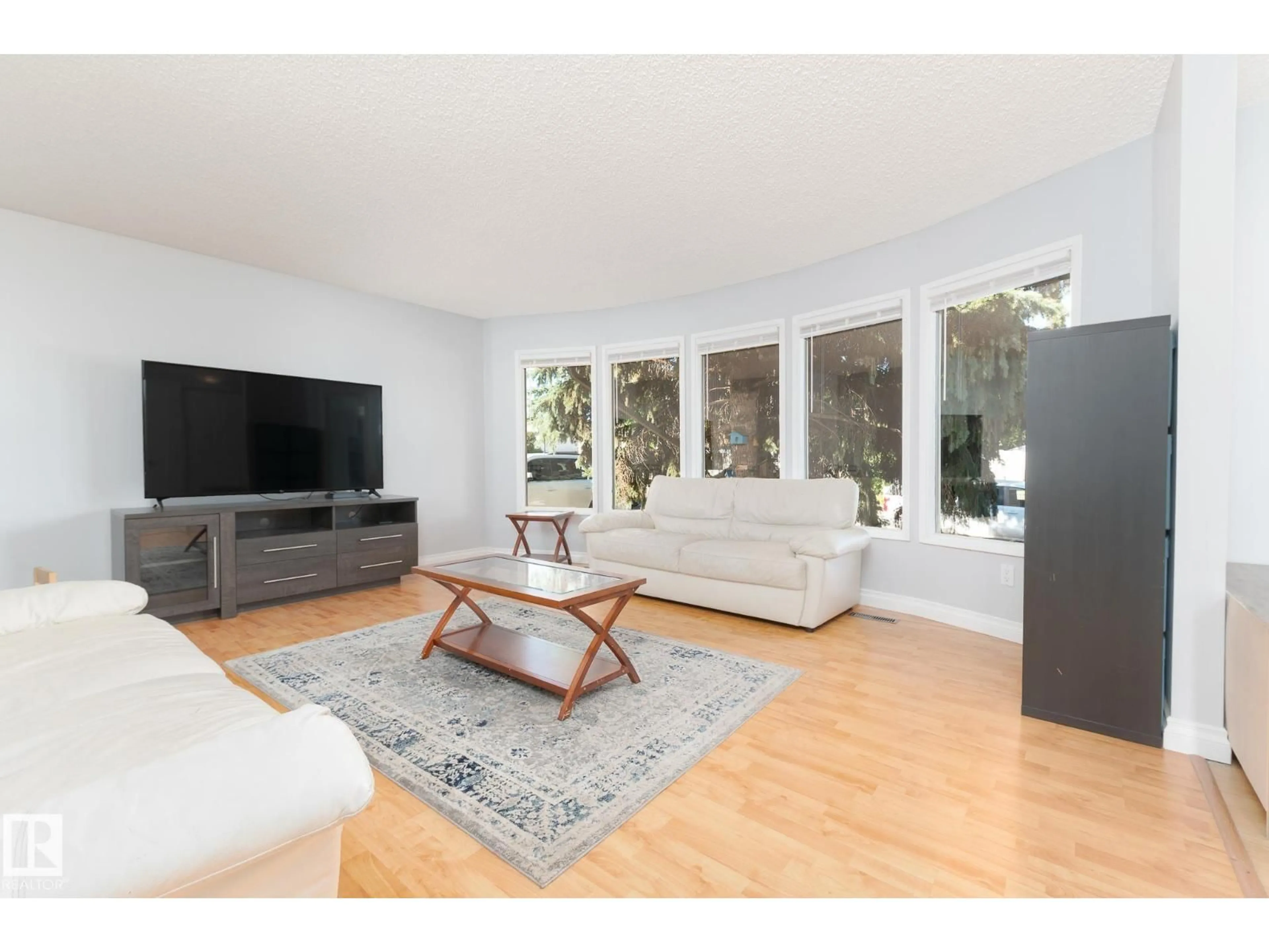 Living room with furniture, wood/laminate floor for 11 OATWAY ST, Spruce Grove Alberta T7X2E5
