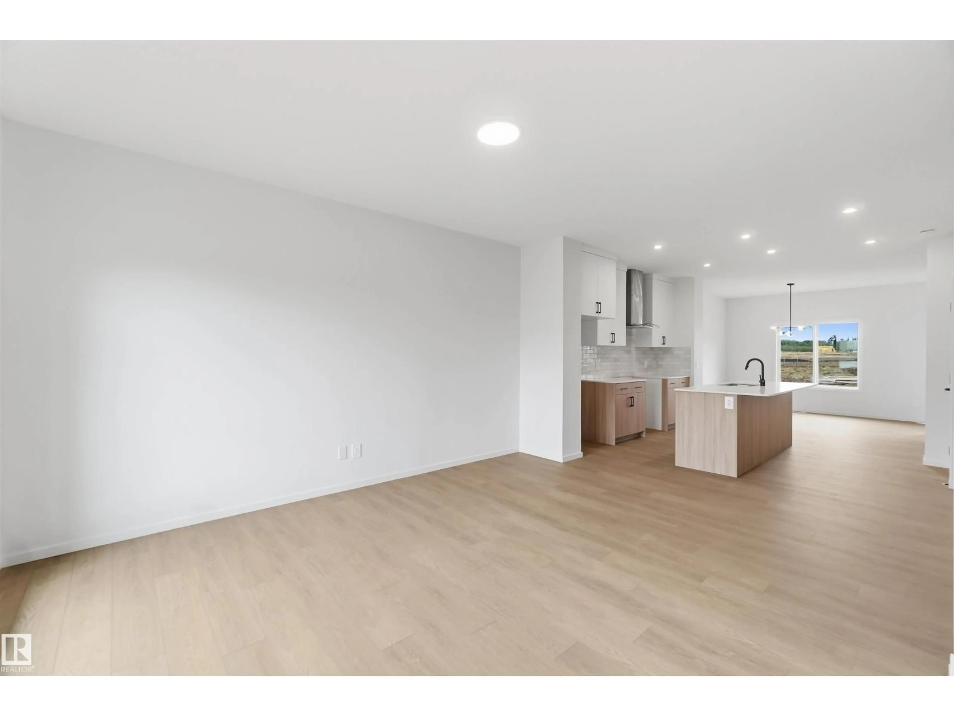 Open concept kitchen, wood/laminate floor for NW NW - 8816 EDGEMONT LI, Edmonton Alberta T6M3K8