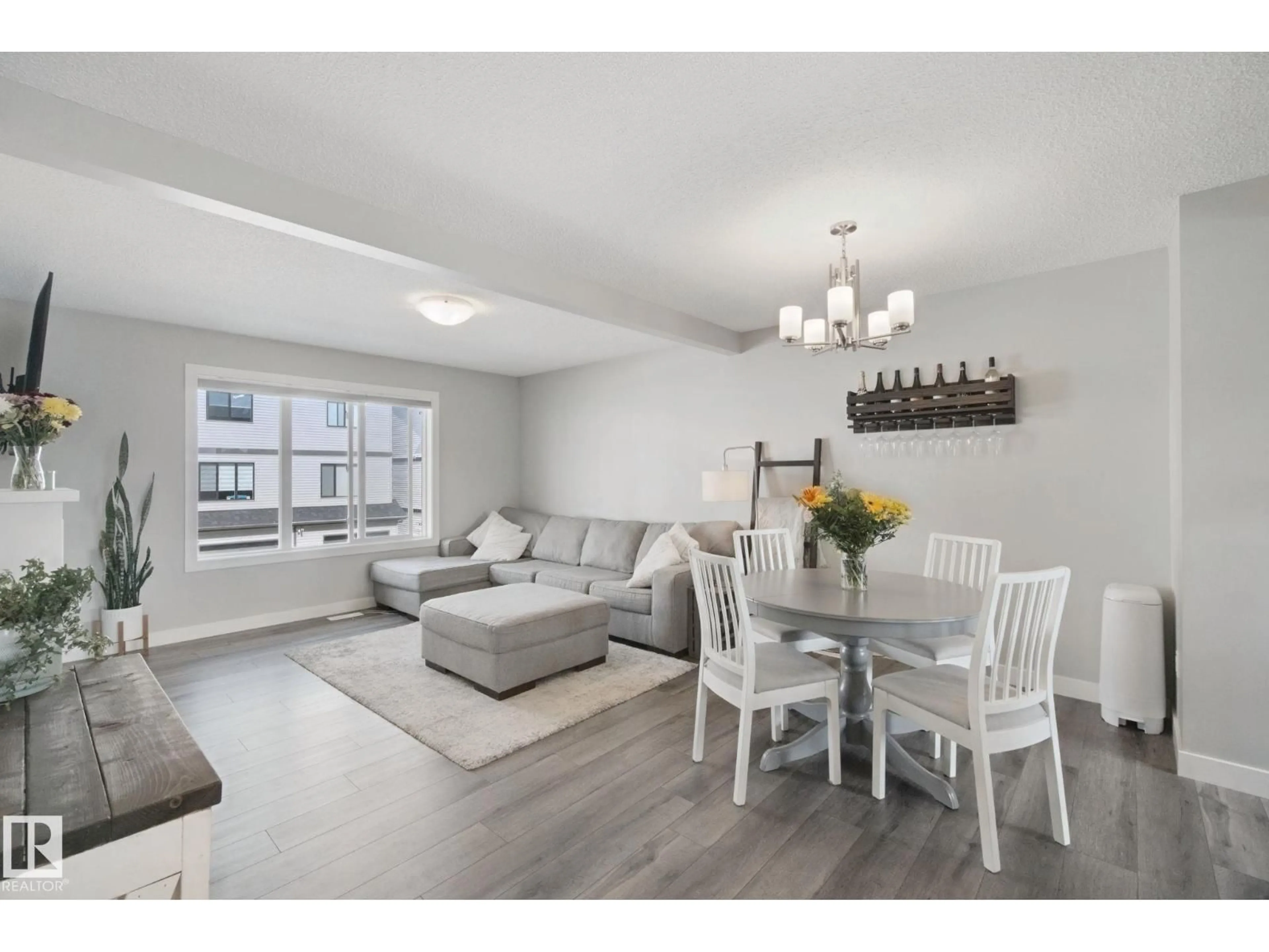 Living room with furniture, wood/laminate floor for 19612 27 AV, Edmonton Alberta T6M0X1