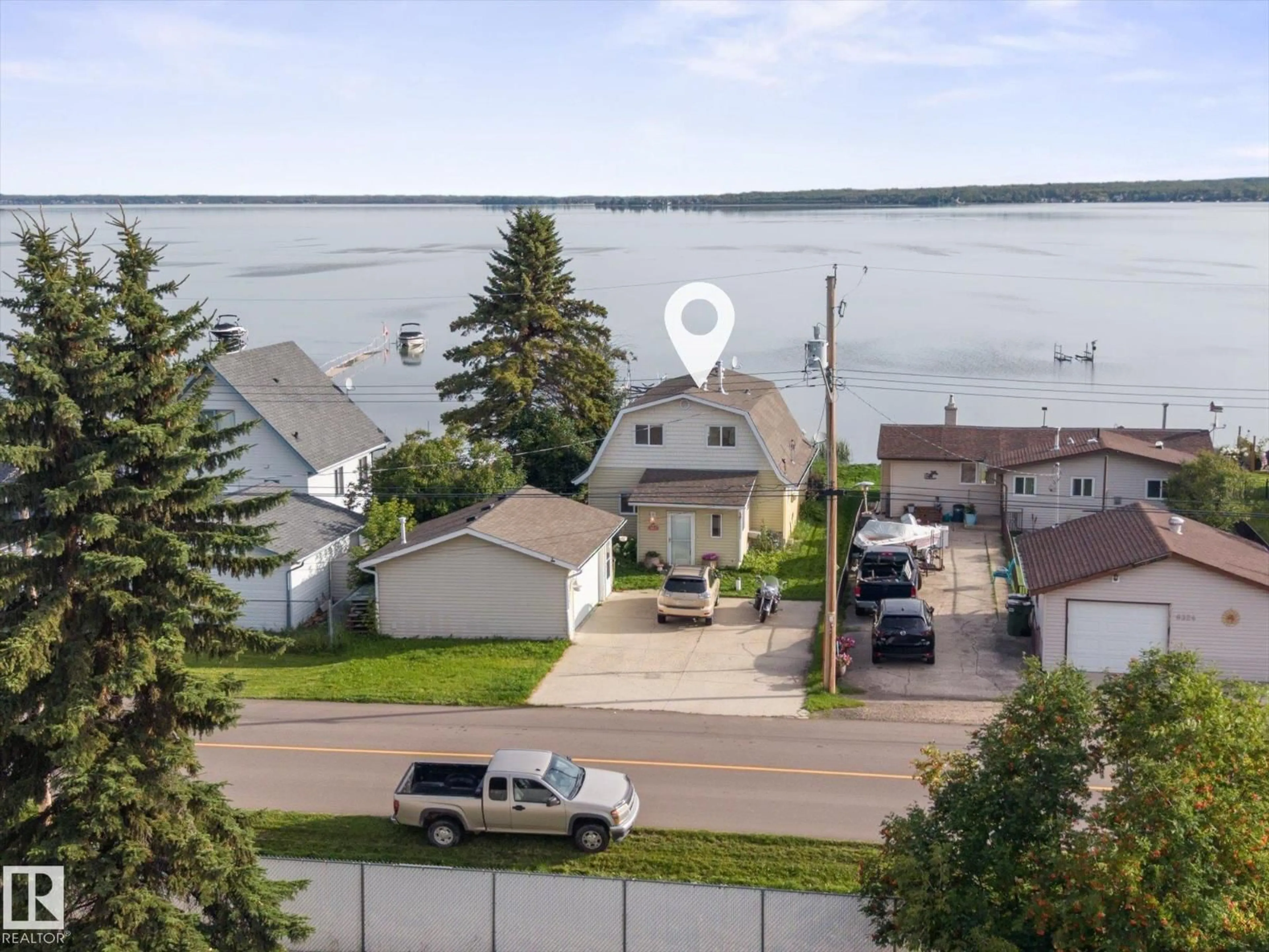 A pic from outside/outdoor area/front of a property/back of a property/a pic from drone, water/lake/river/ocean view for 6326 50 AV, Rural Lac Ste. Anne County Alberta T0E0A0