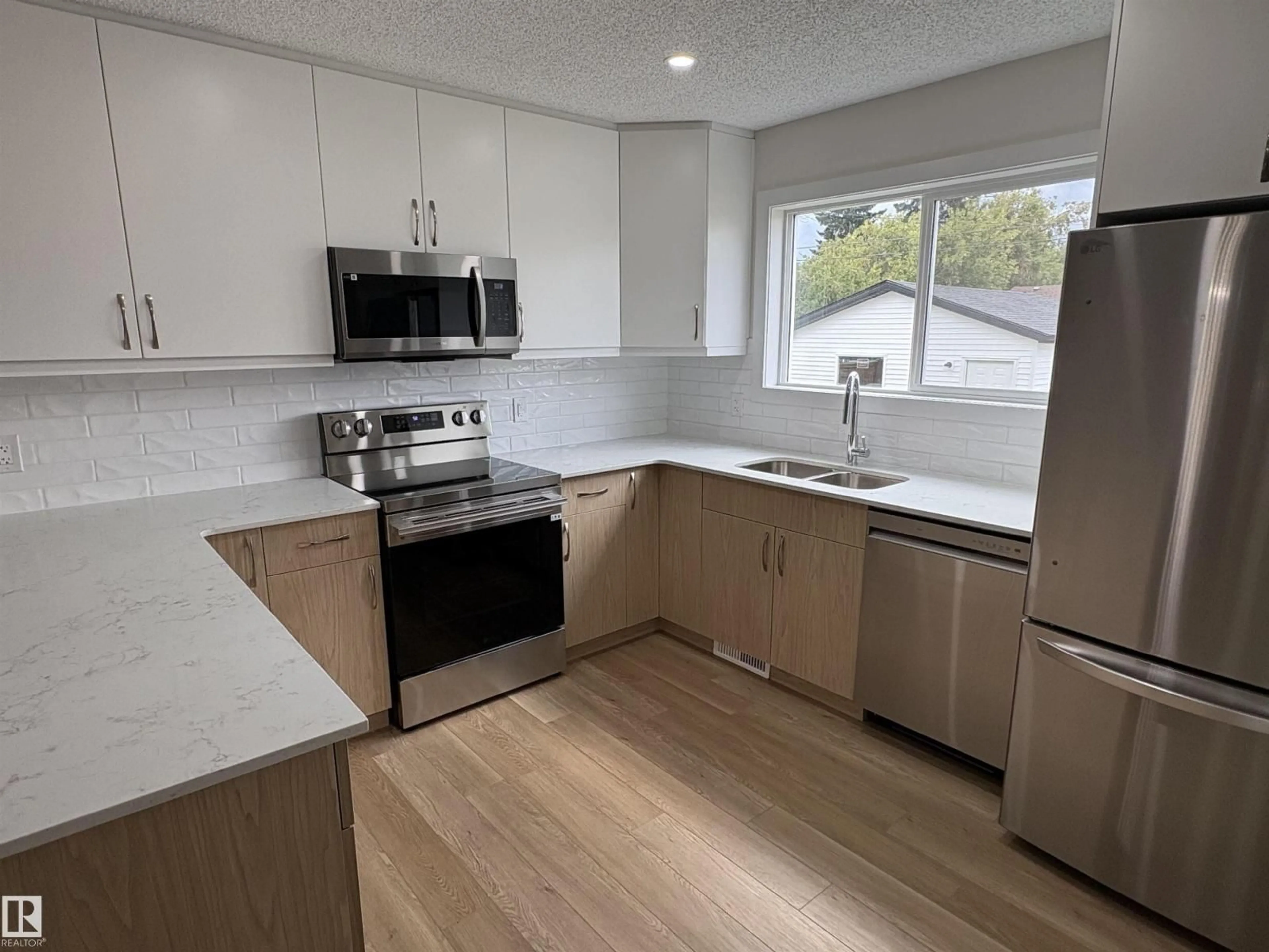 Open concept kitchen, wood/laminate floor for 4843 115 AV, Edmonton Alberta T5W0W3