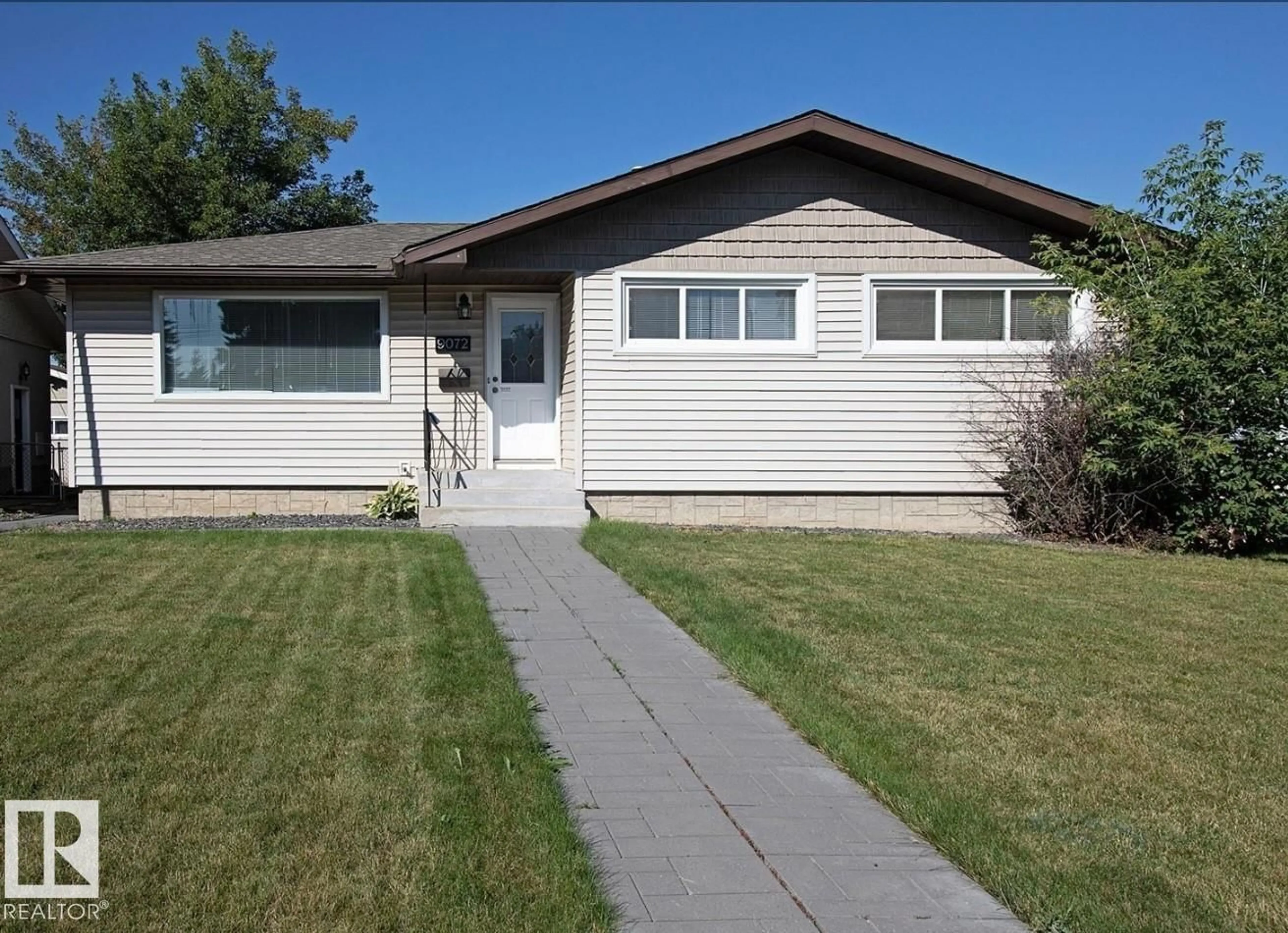 Home with vinyl exterior material, street for 9072 52 ST, Edmonton Alberta T6B1G2