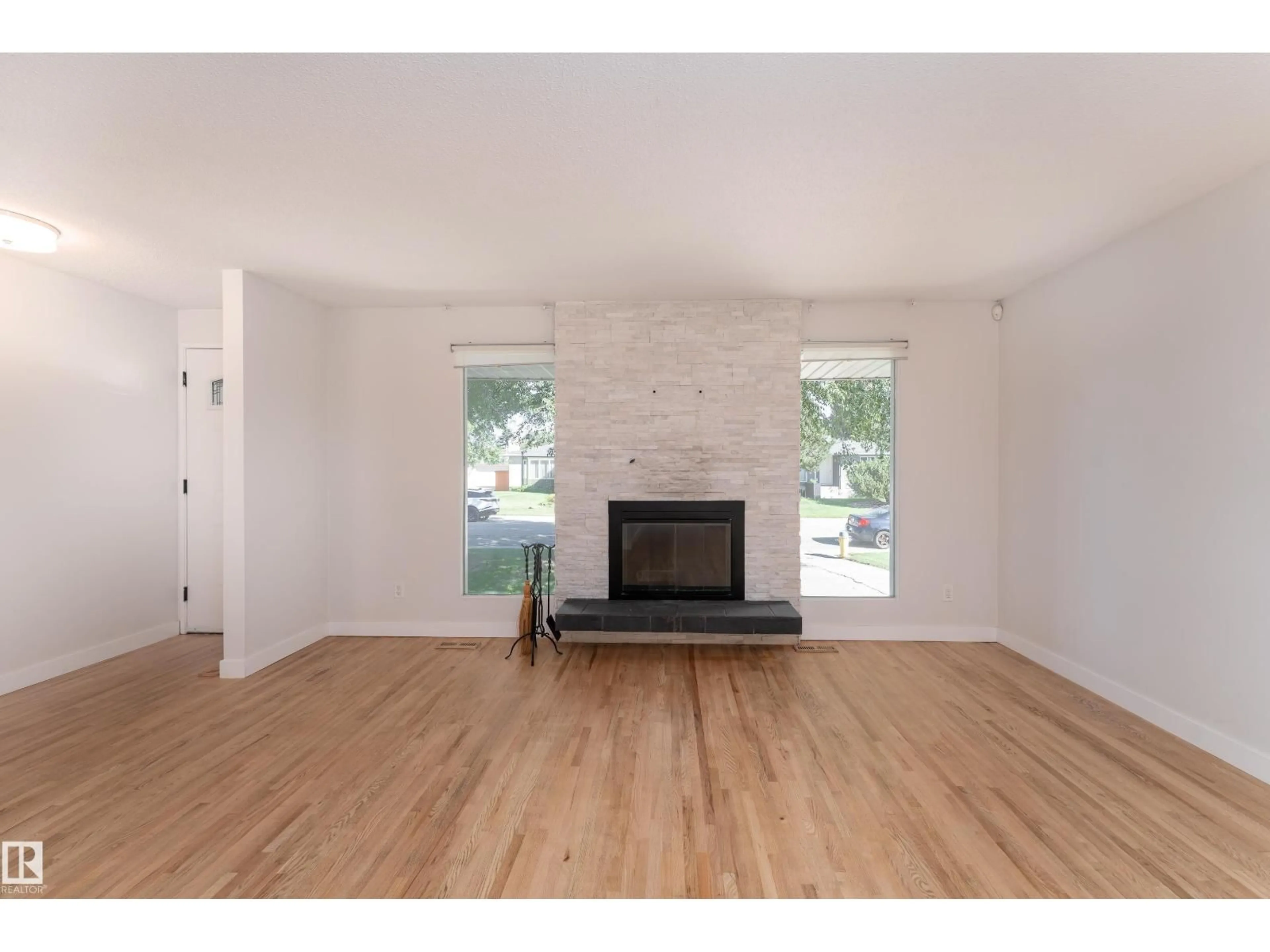 Living room with furniture, wood/laminate floor for 10415 39A AV, Edmonton Alberta T6J2J5