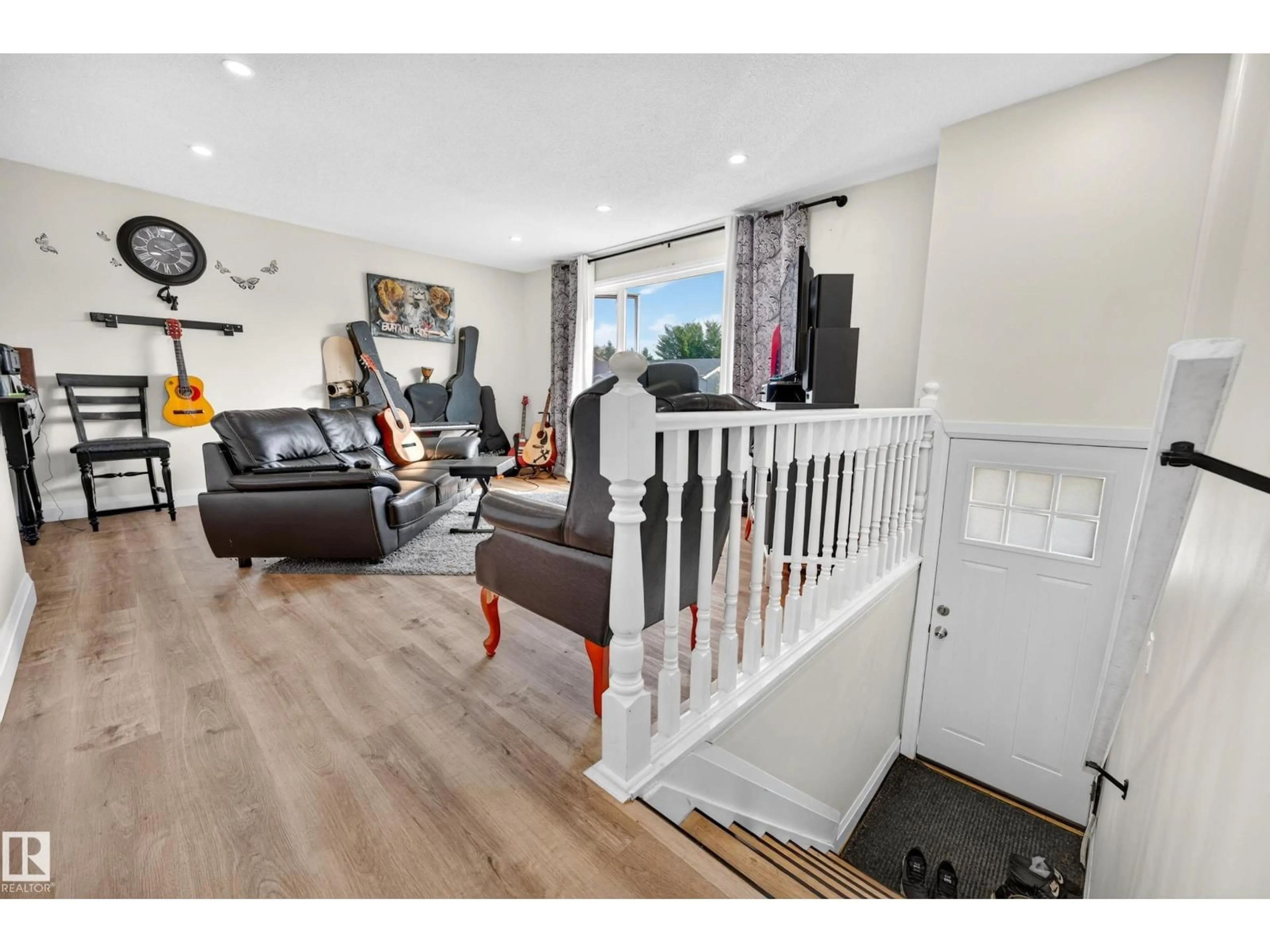 Living room with furniture, wood/laminate floor for 2412 80 ST, Edmonton Alberta T6K3P6