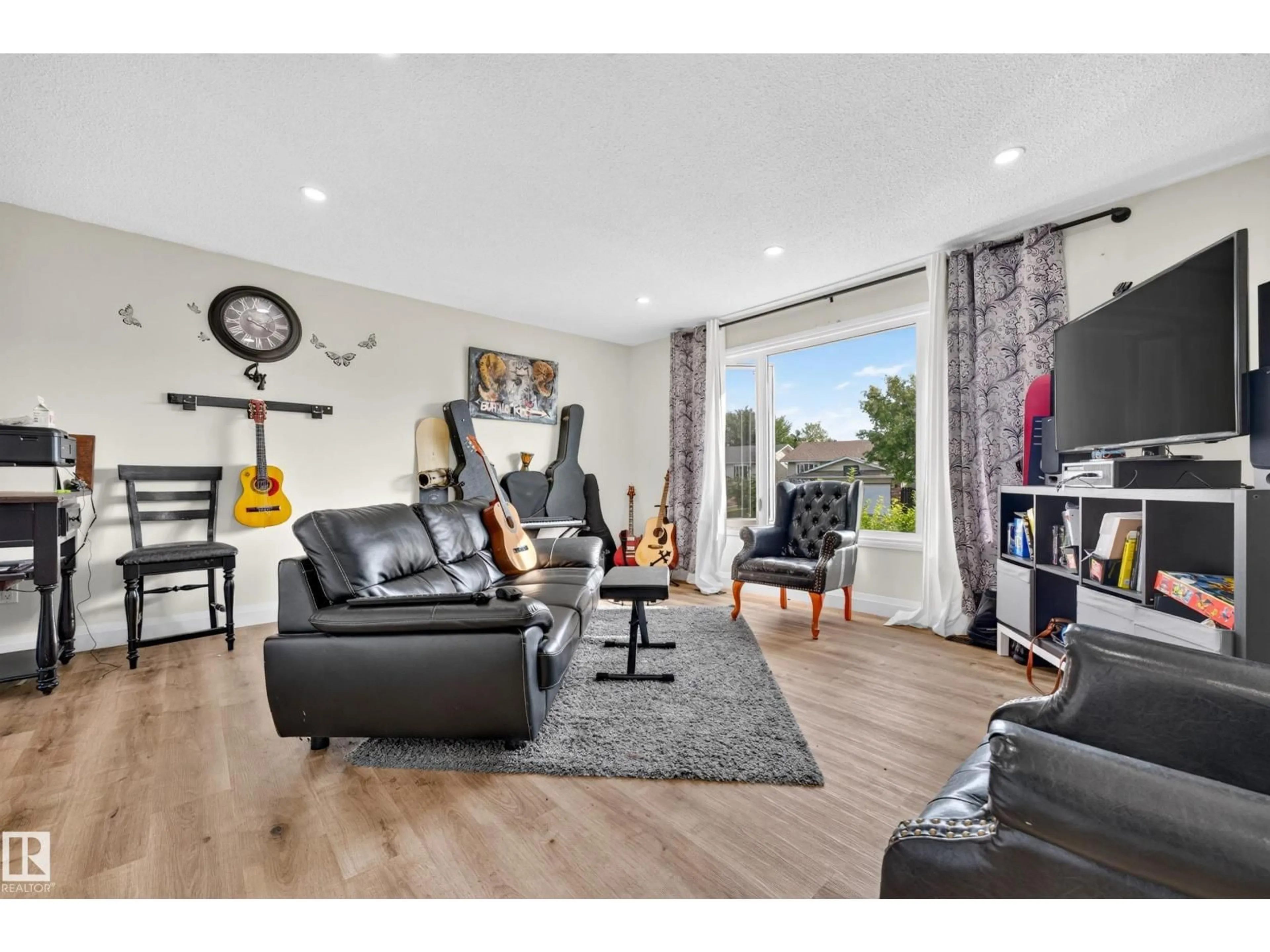 Living room with furniture, wood/laminate floor for 2412 80 ST, Edmonton Alberta T6K3P6