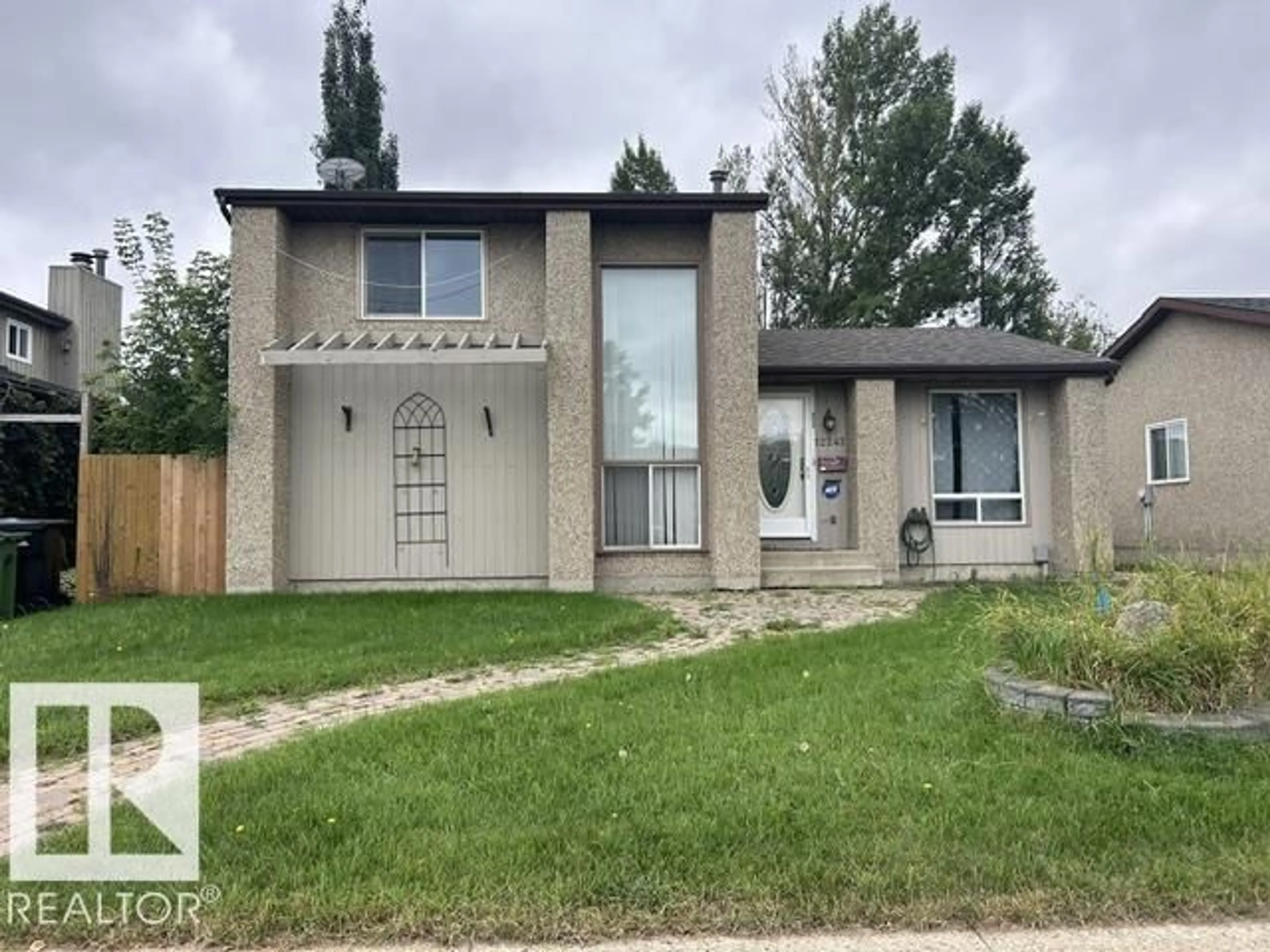 Home with vinyl exterior material, street for 12247 144 AV, Edmonton Alberta T5X3M3